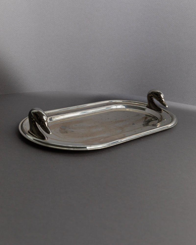Vintage 1960s Silver Plated Tray, Oval with Twin Swan Head Handles — close-up of tray on gray surface