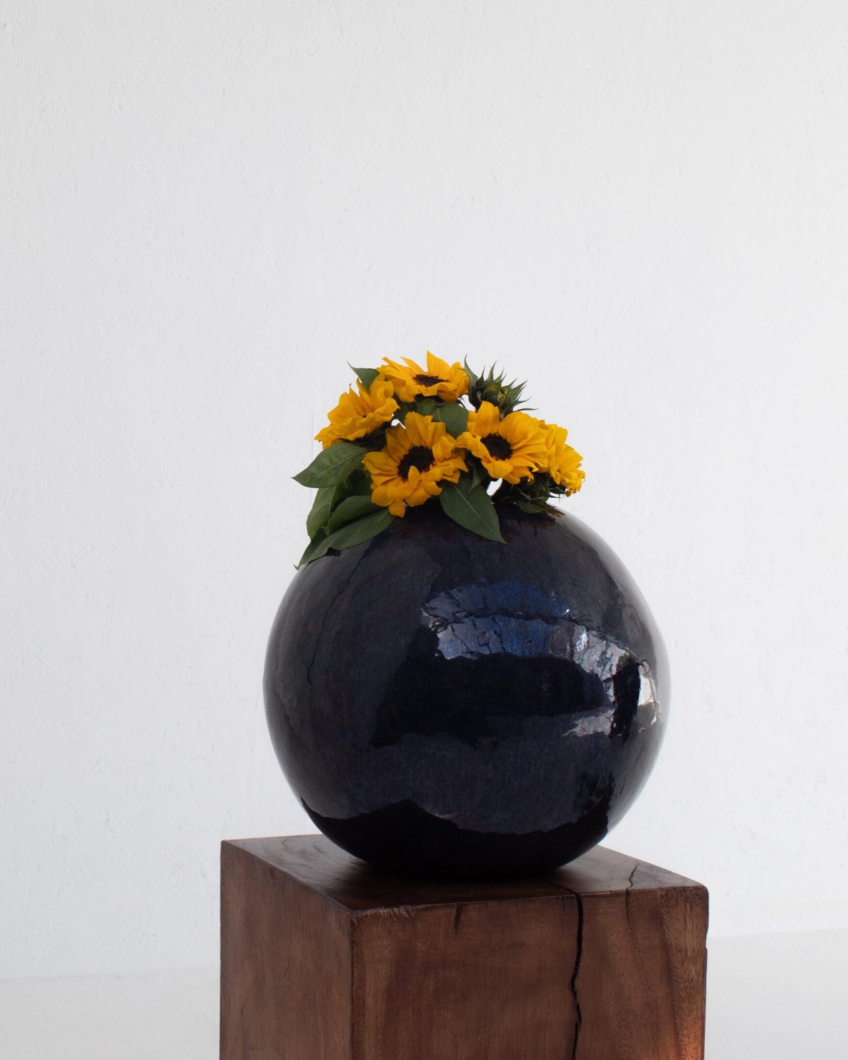 Vintage Spherical Ceramic Vase — close-up of dark ceramic with flowers