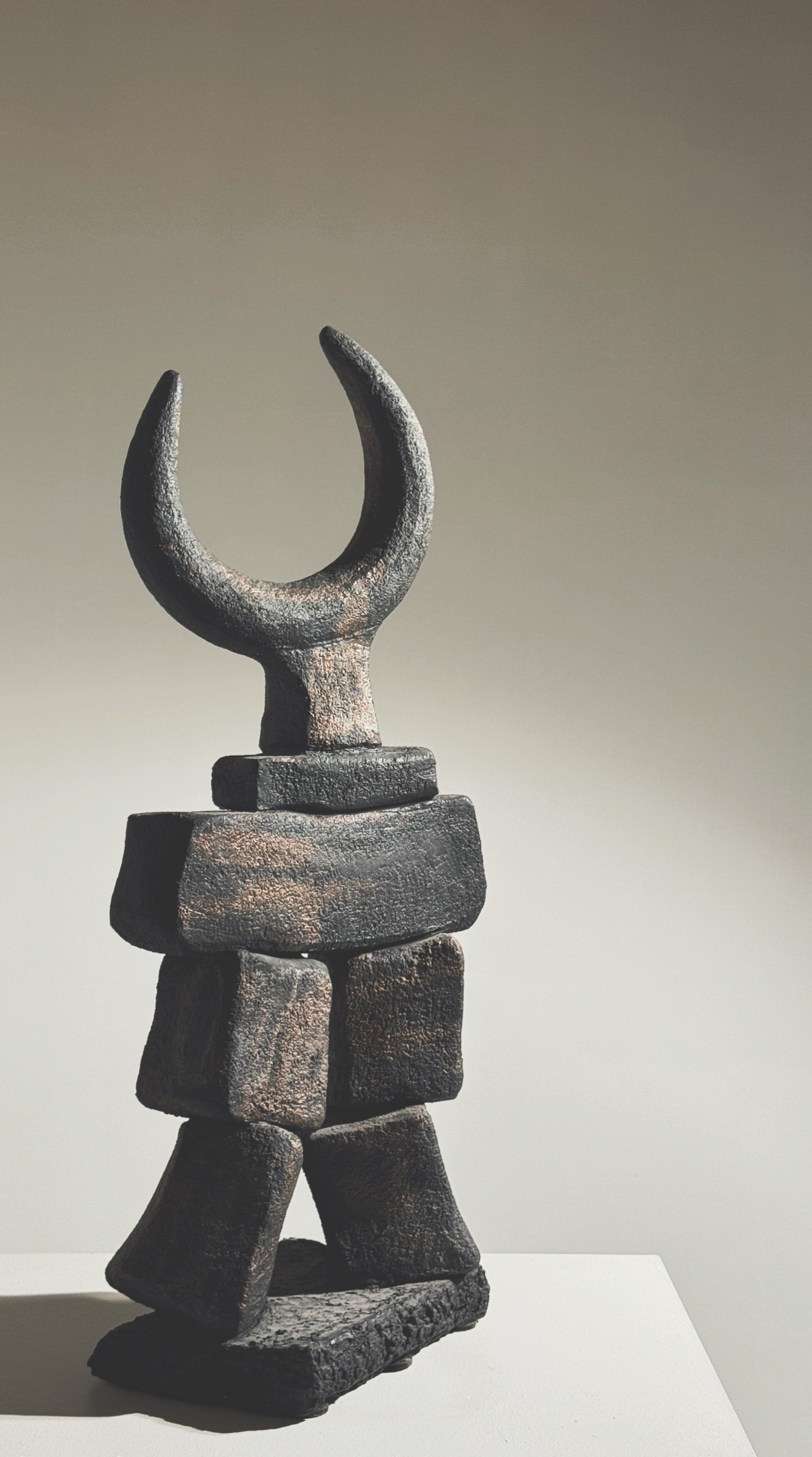 Stacked stone blocks sculpture with crescent moon top by Pouchain