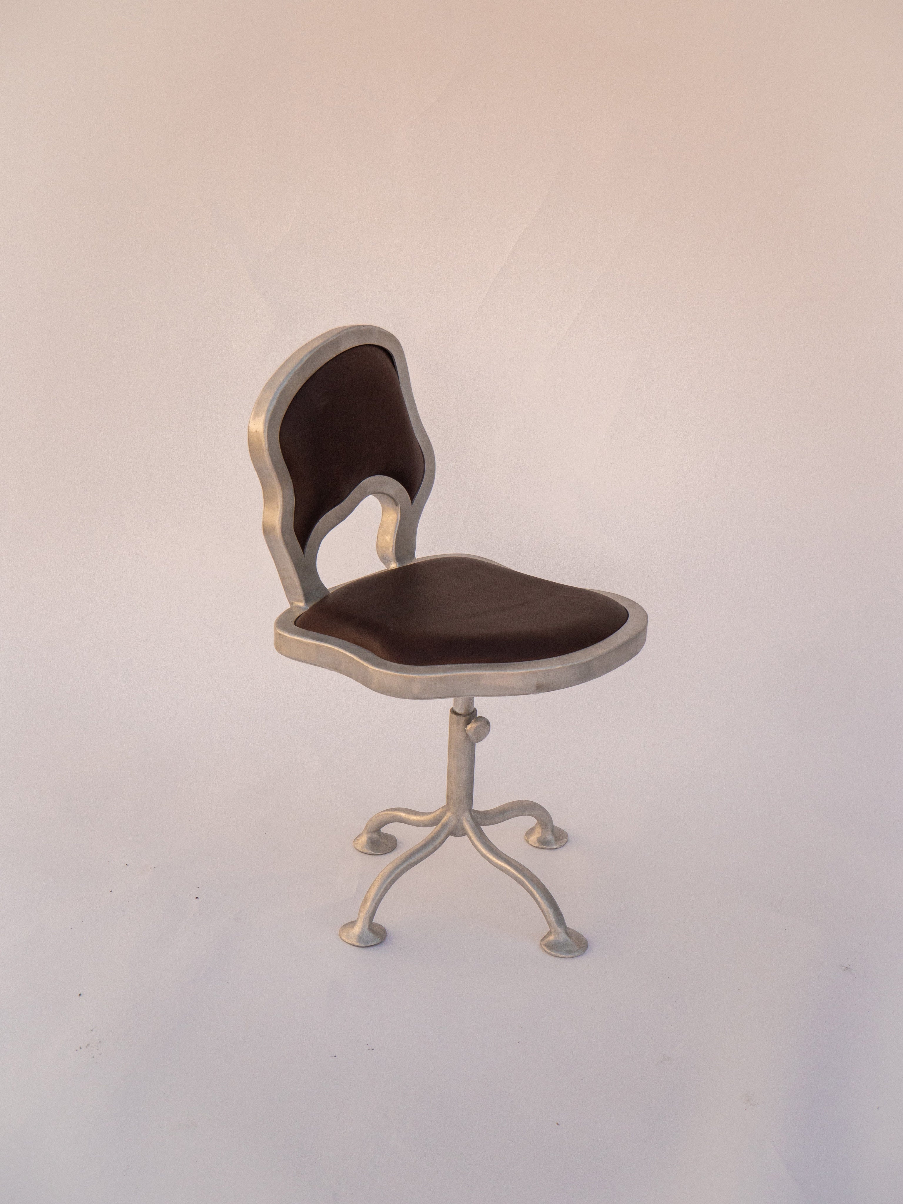 Contemporary Office Chair — side view of metal frame and leather seat