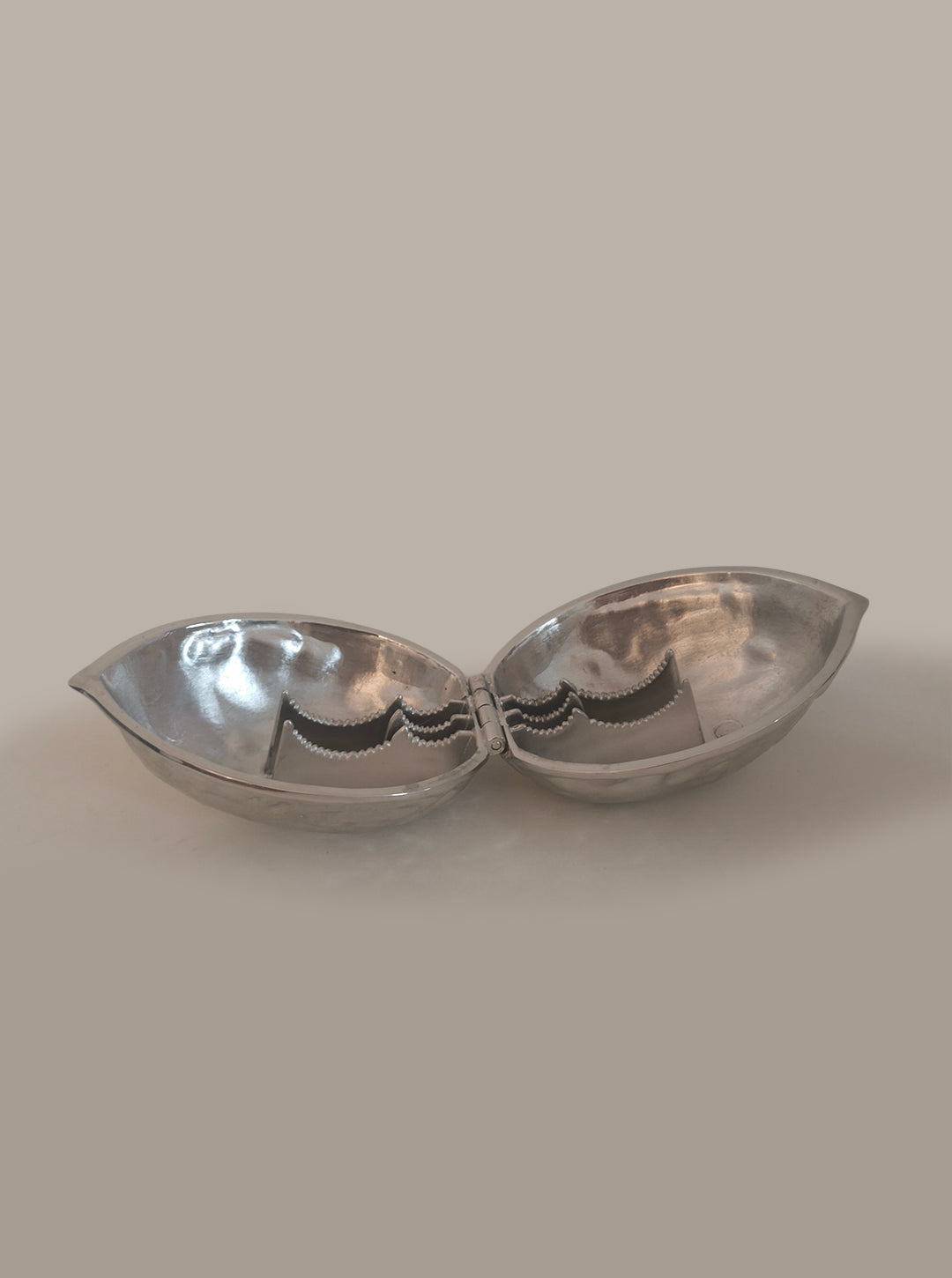 Stainless Steel Nutcracker — open view on neutral background
