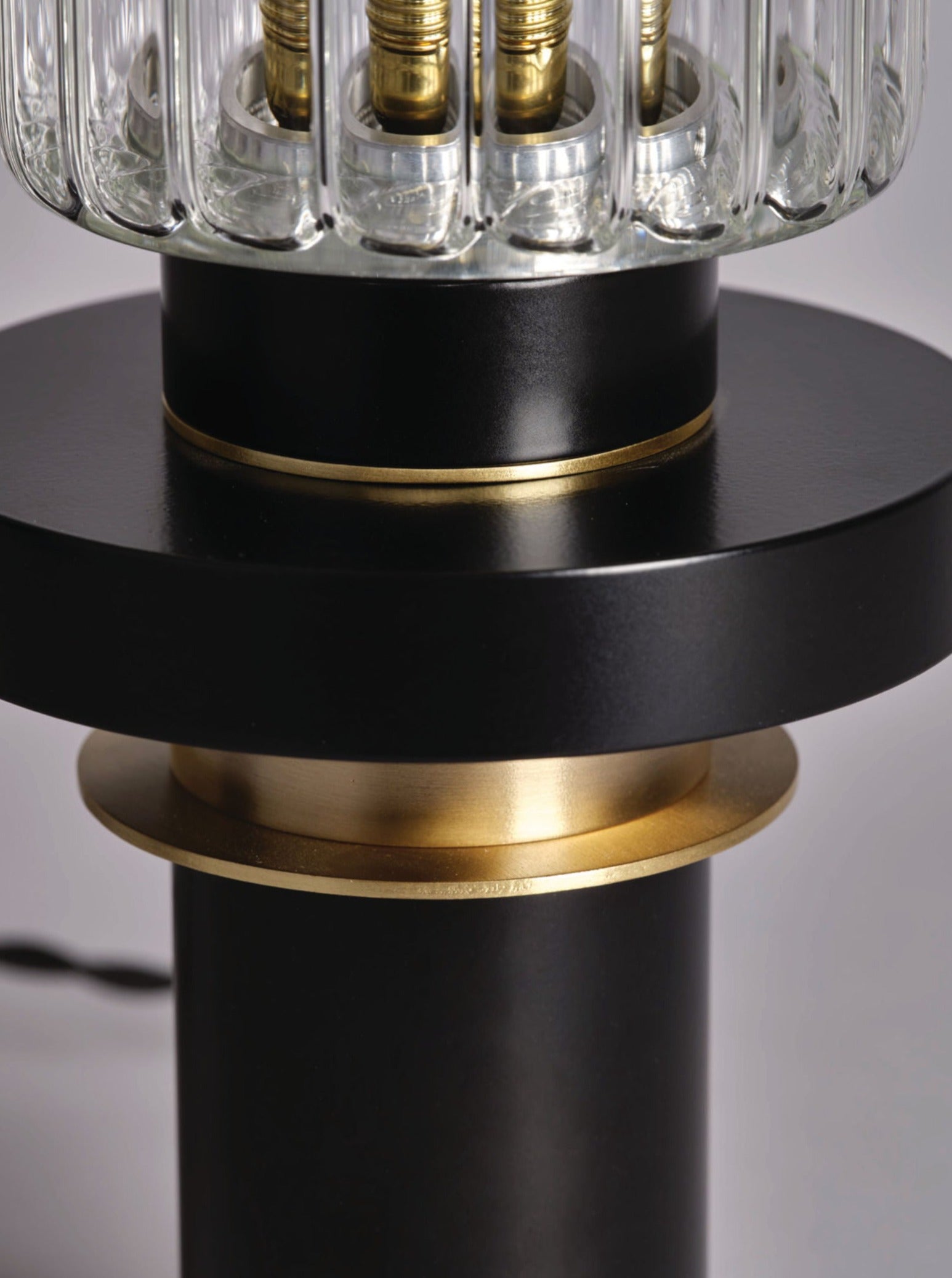 Alexandre Table Lamp — close-up of black base with brass accents