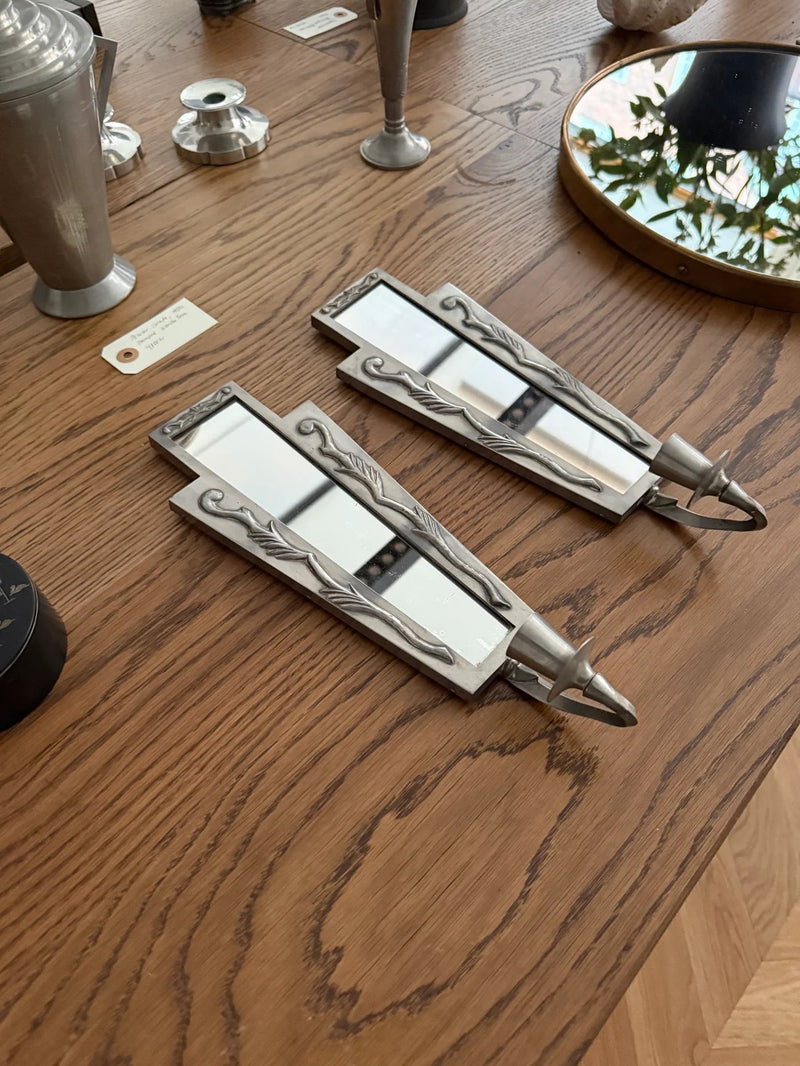 Pair of Swedish Grace Pewter Candle Sconces with Mirrors — close-up on wooden table with reflections
