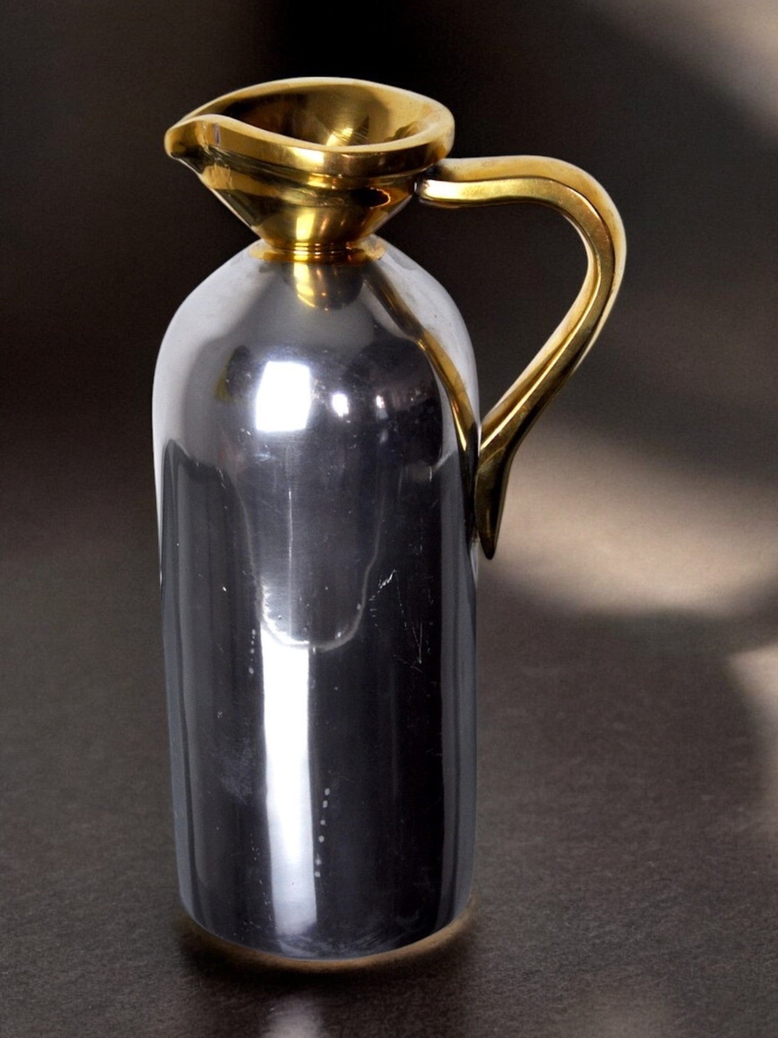 Brutalist Pitcher by David Marshall, 1980s, Spain — close-up of polished metal body and gold handle