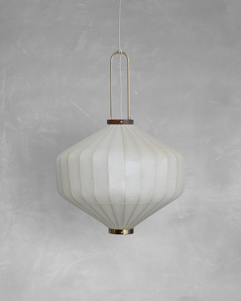 White pleated fabric pendant light with brass hardware hanging view