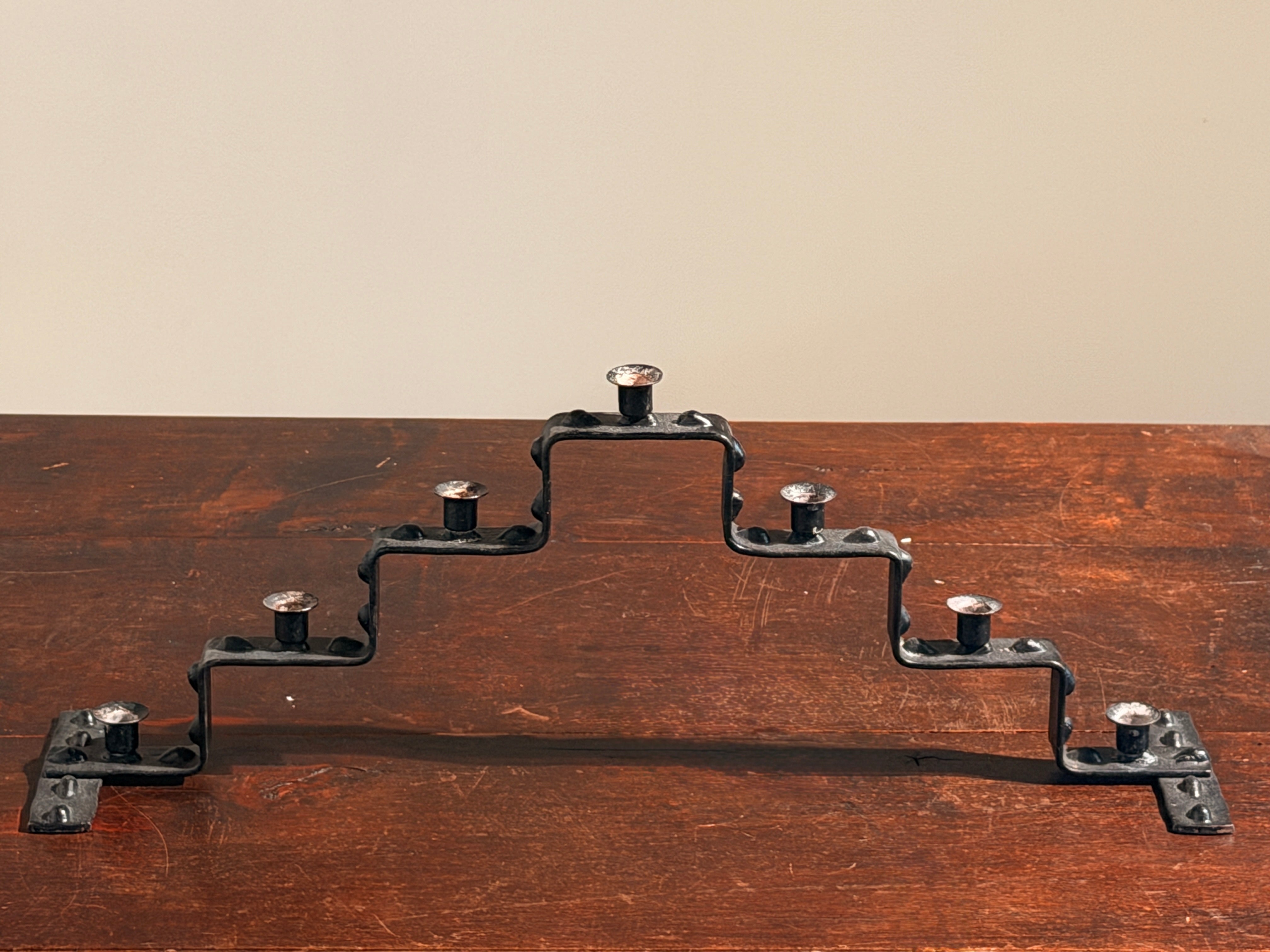 Seven-light geometric candelabra in black iron, circa 1960 — lifestyle setting