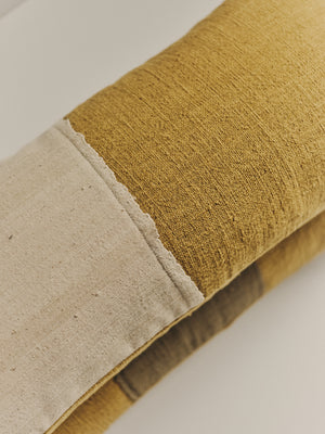Handwoven cushion in beige and green — detail view