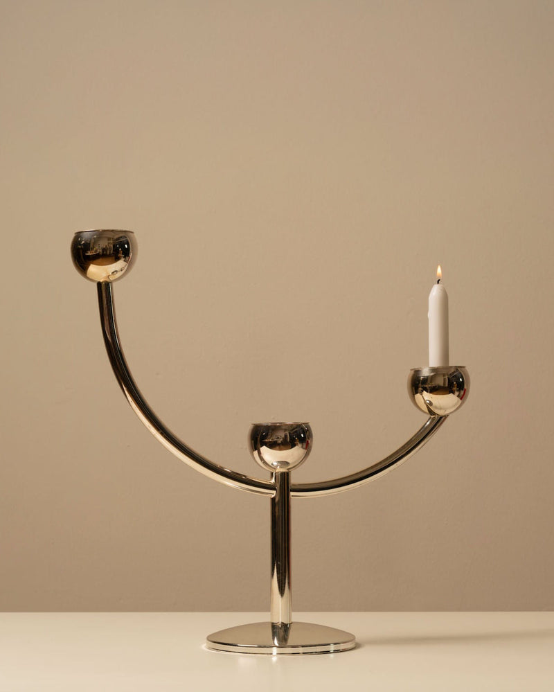 Vintage modernist chrome candleholder with three holders and lit candle