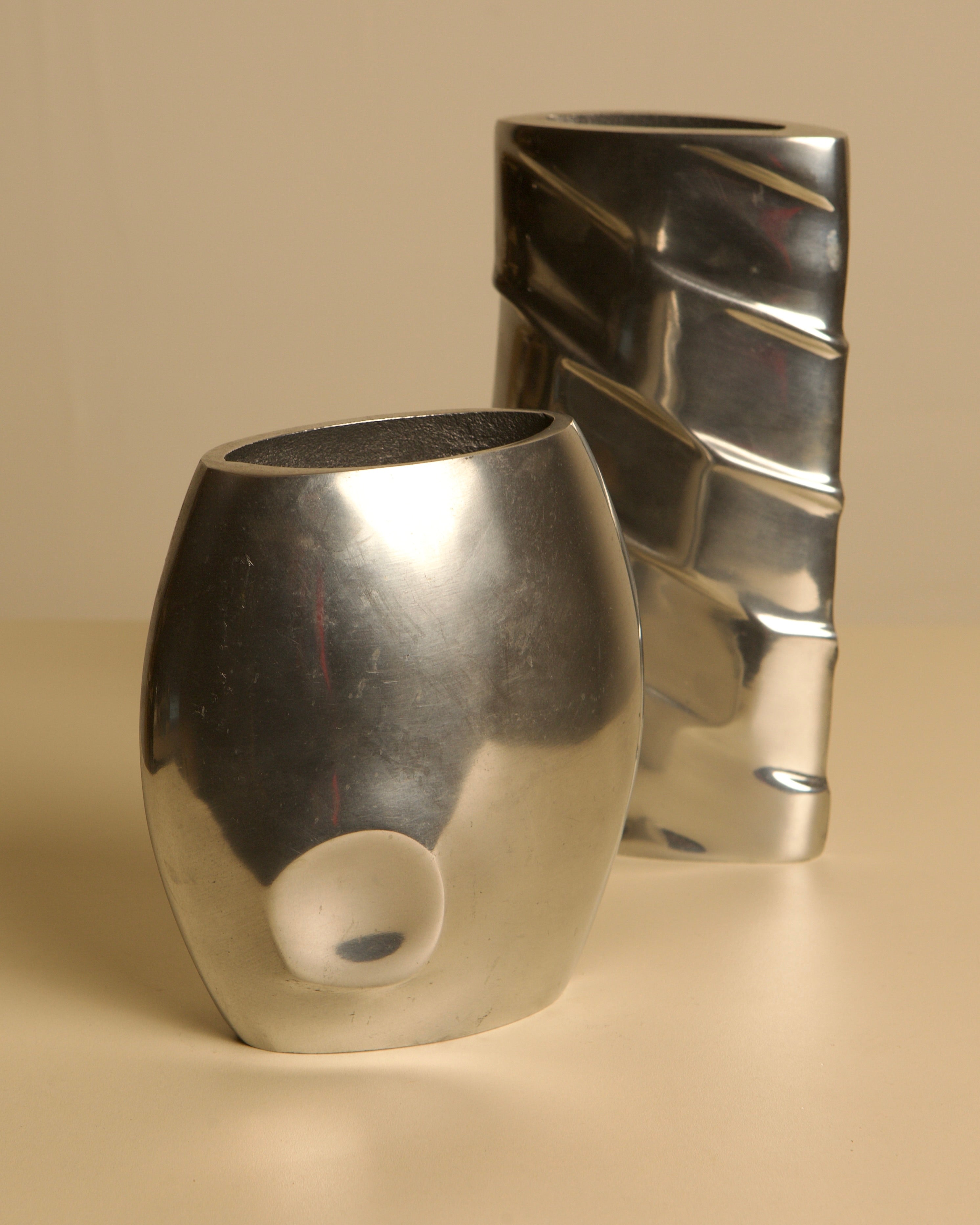 Pair of Italian Cast Aluminum Vases, 1980s — angled view on neutral background