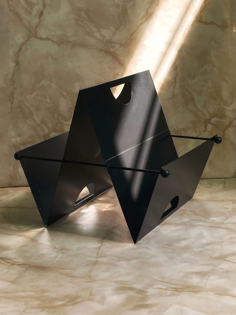 Black geometric Italian postmodern magazine rack with angular design