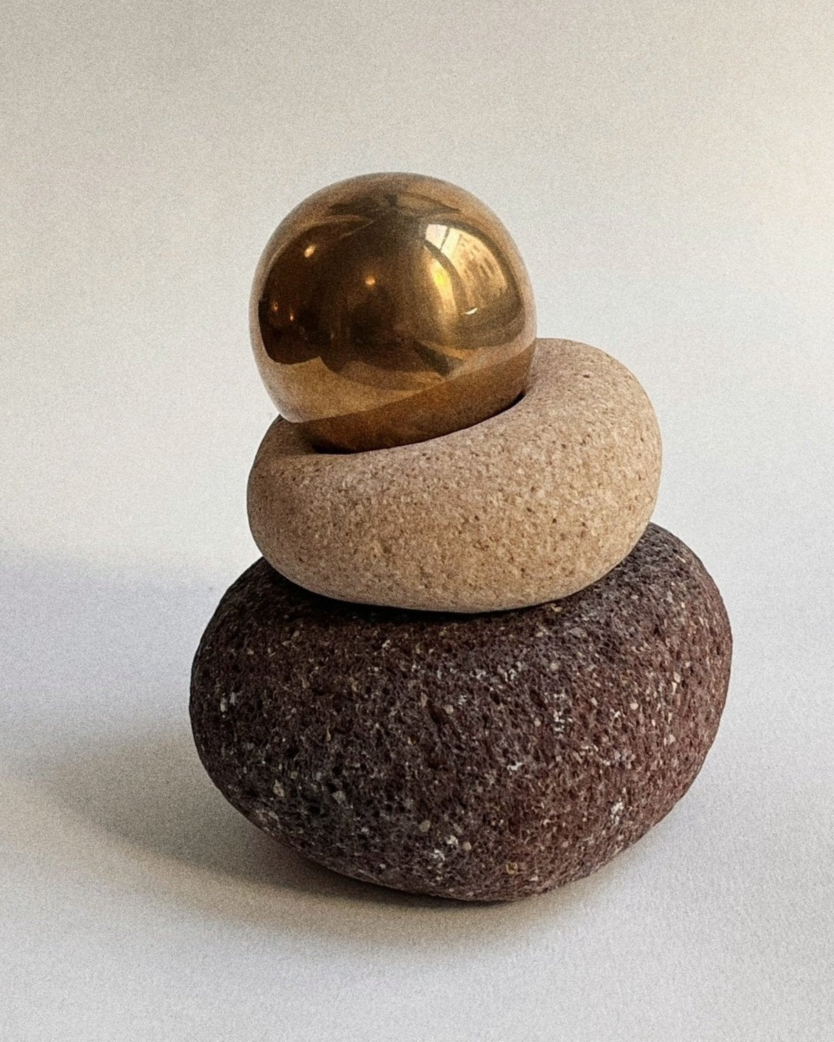 CERCLE Cabinet Knob Large — stacked on textured stone arrangement