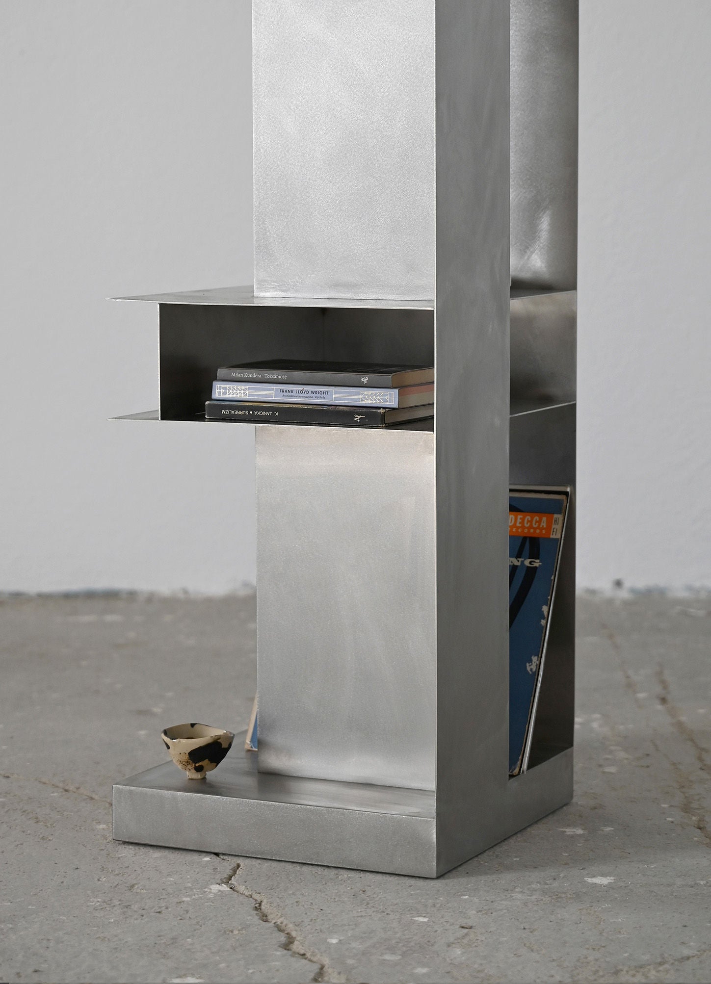 ZEN' Standing Shelf — back view with brushed metal finish and books