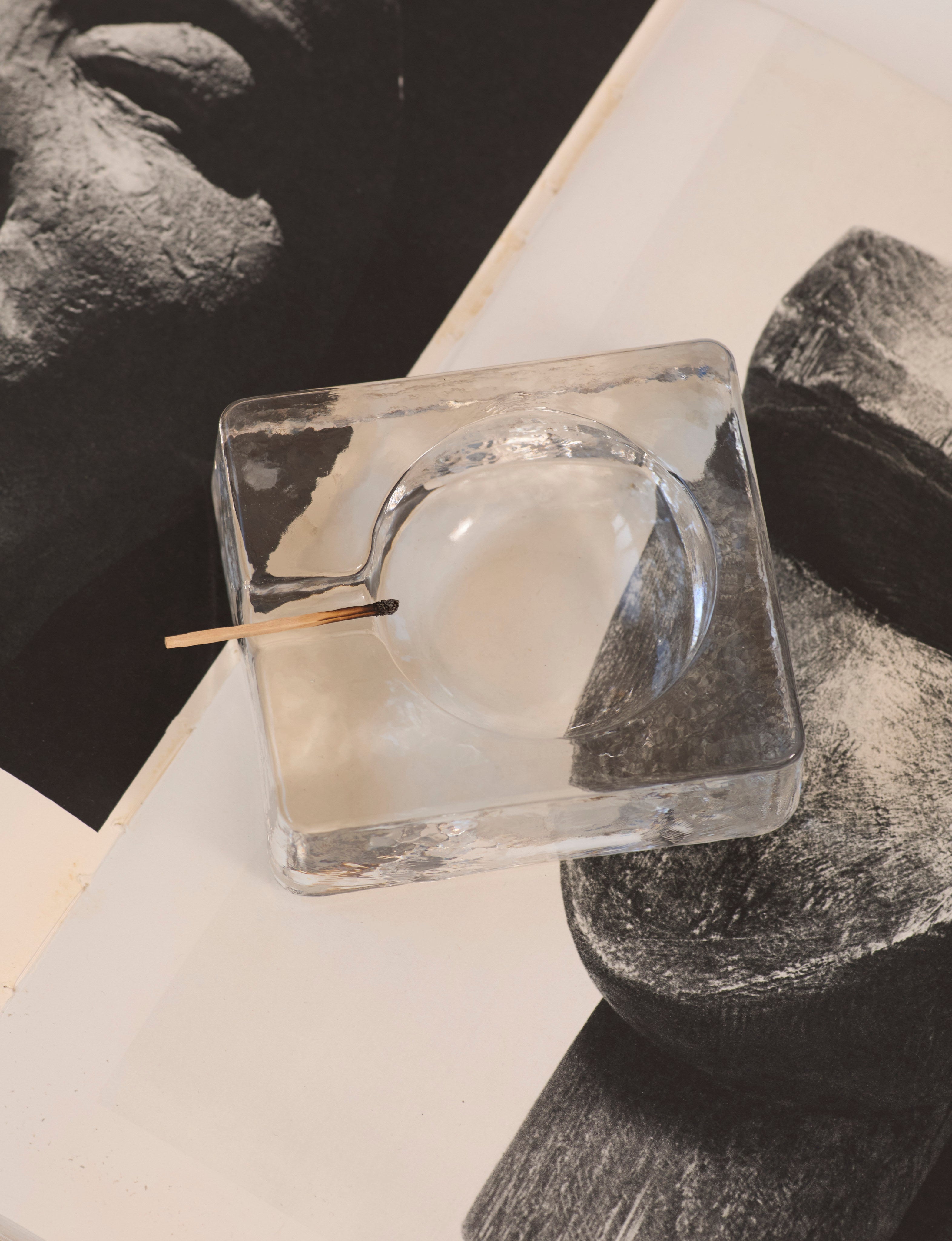Scandinavian Clear Ashtray in Glass — top view on art book pages