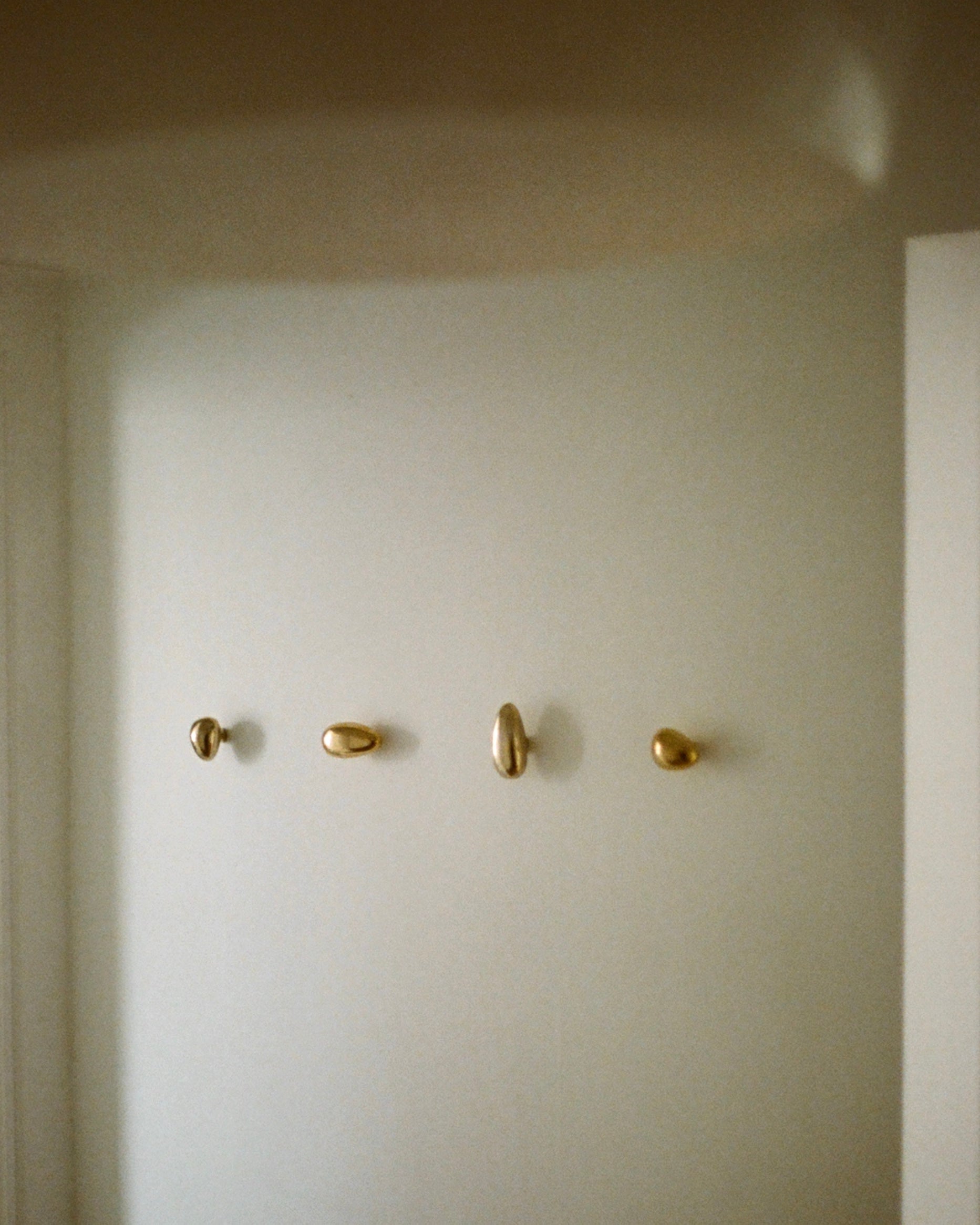 MOMI Cabinet Knob/Wall Hook Short Mini — mounted on white wall