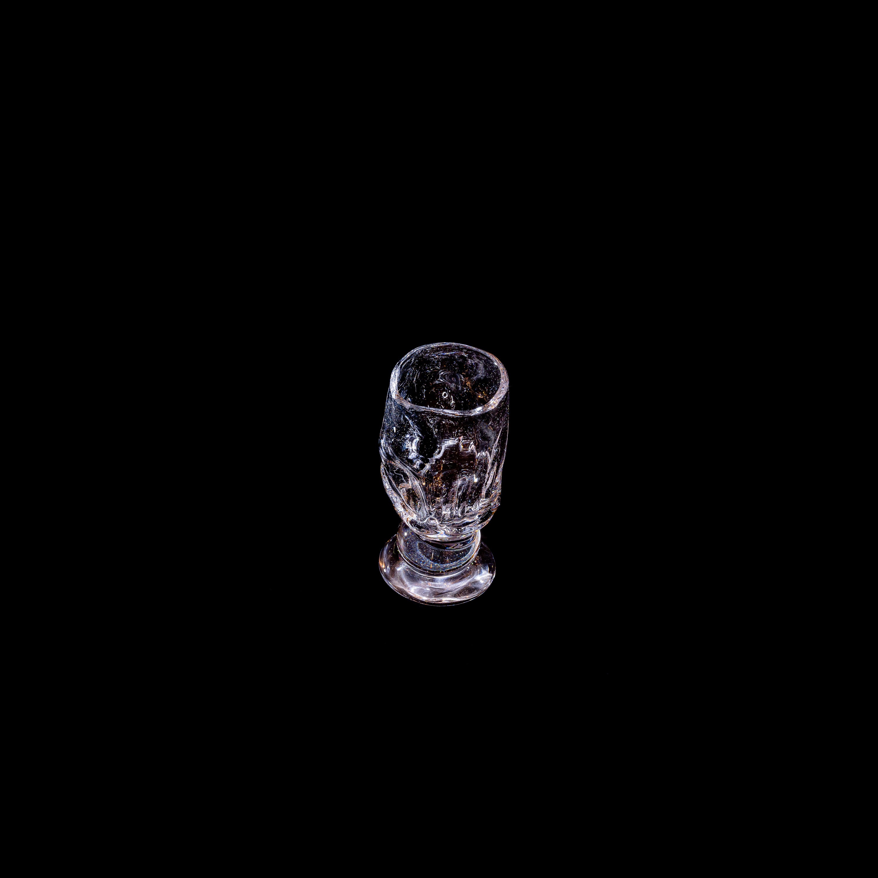 Round Free-shaped Glass — back view on black background