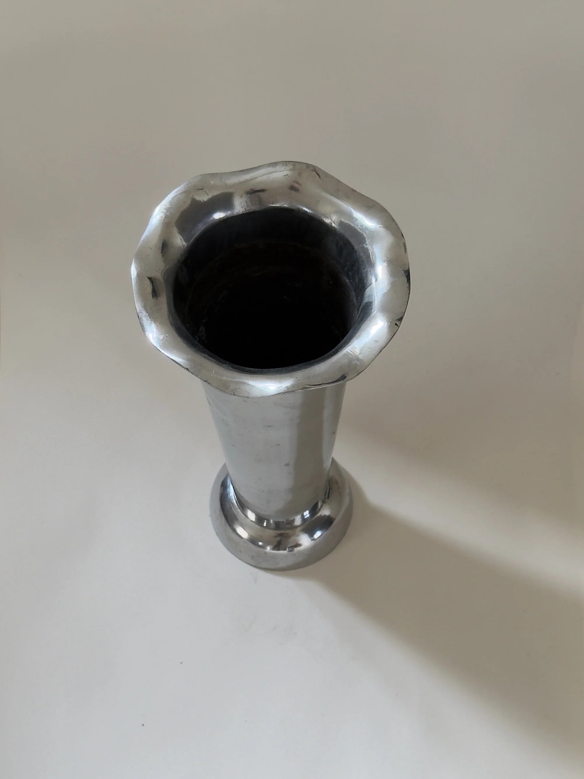 Tall Sculptural Trumpet Vase with Scalloped Rim — top view of polished metal finish