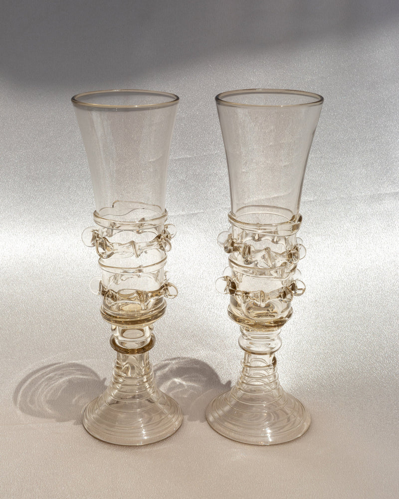 Pair of handblown glass champagne flutes with seaweed-inspired stems