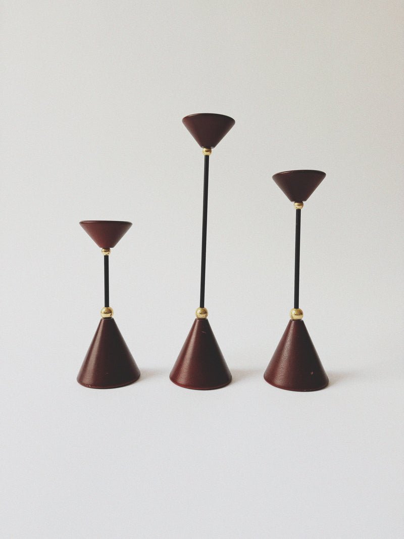 Set of Postmodern Candle Holders in Wood and Metal — close-up of red cone shapes with black stems