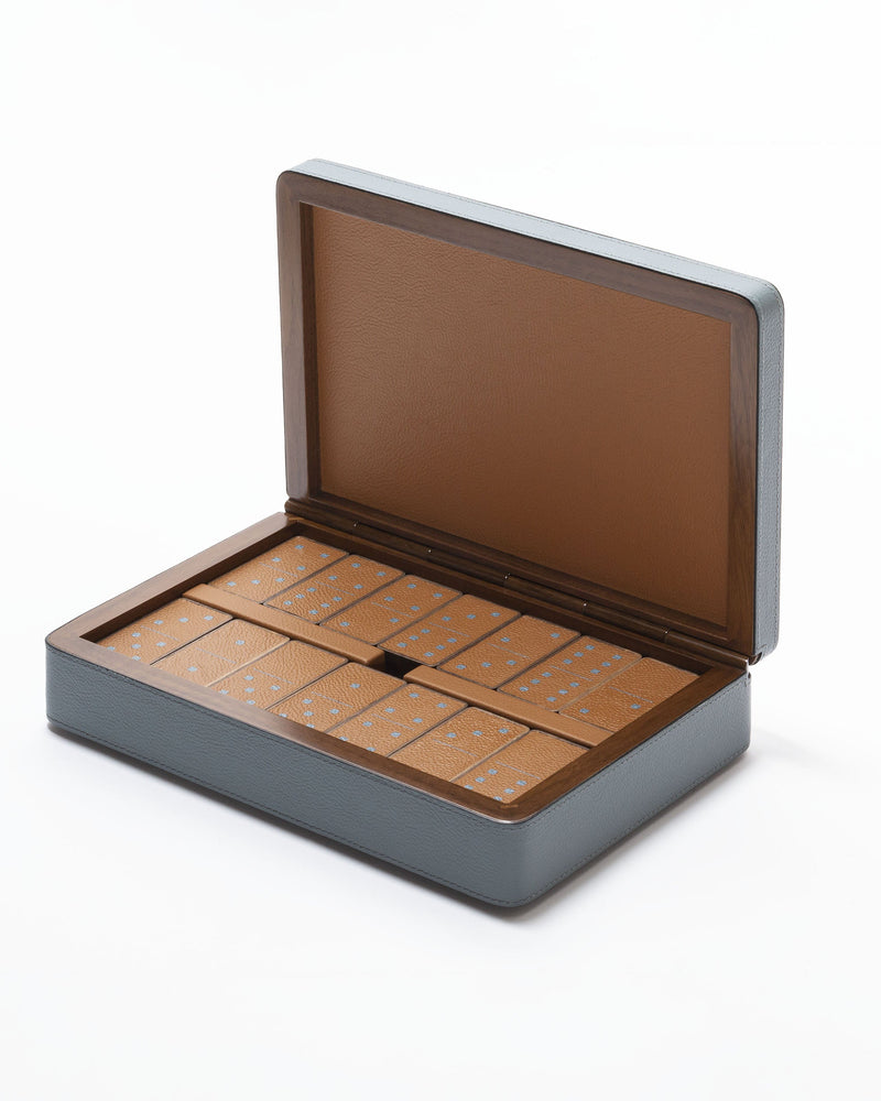 Open domino set in grey leather box showing wooden tiles with blue dots