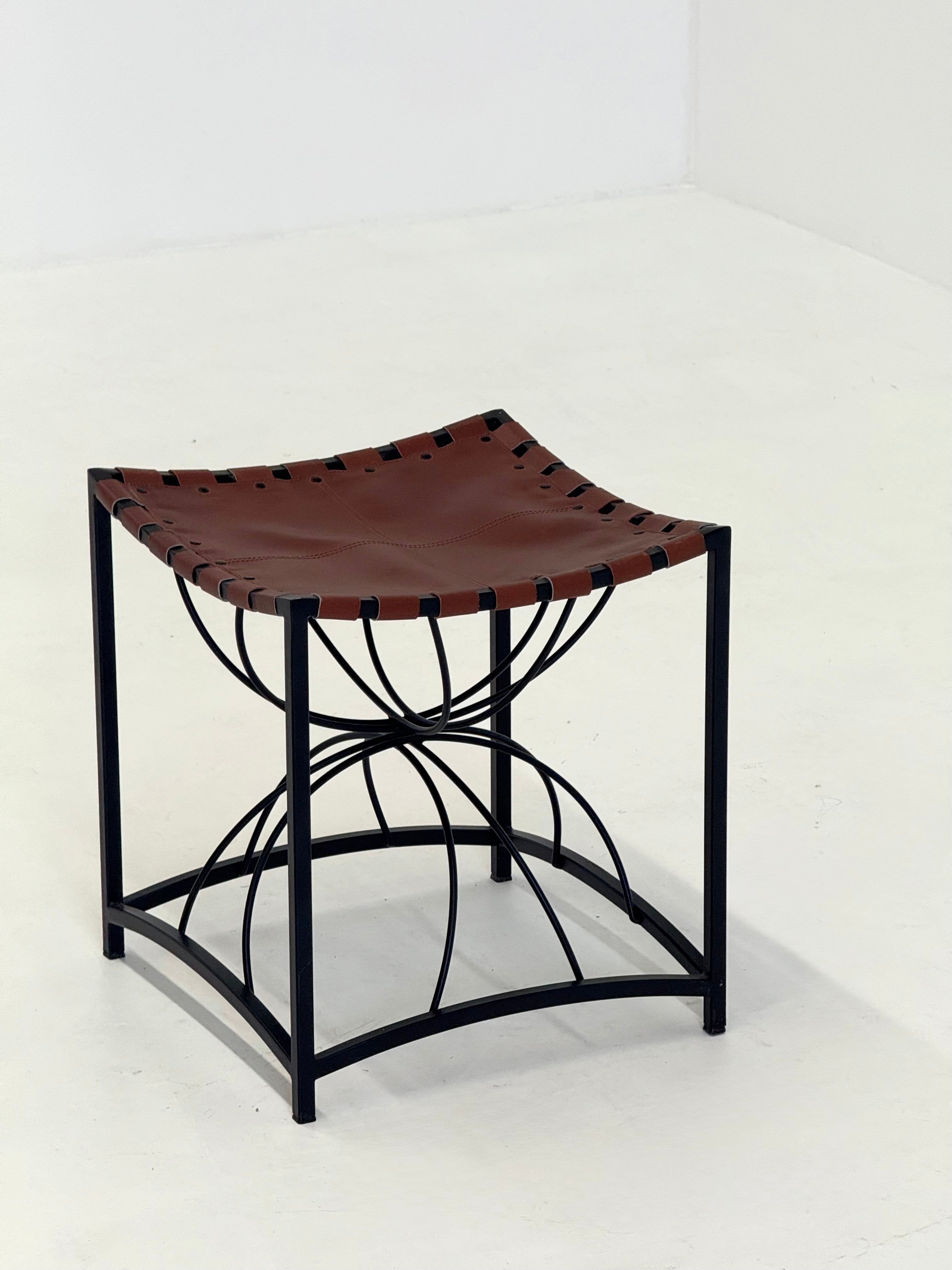 Elegant vintage French stool with black metal and brown leather — side angle