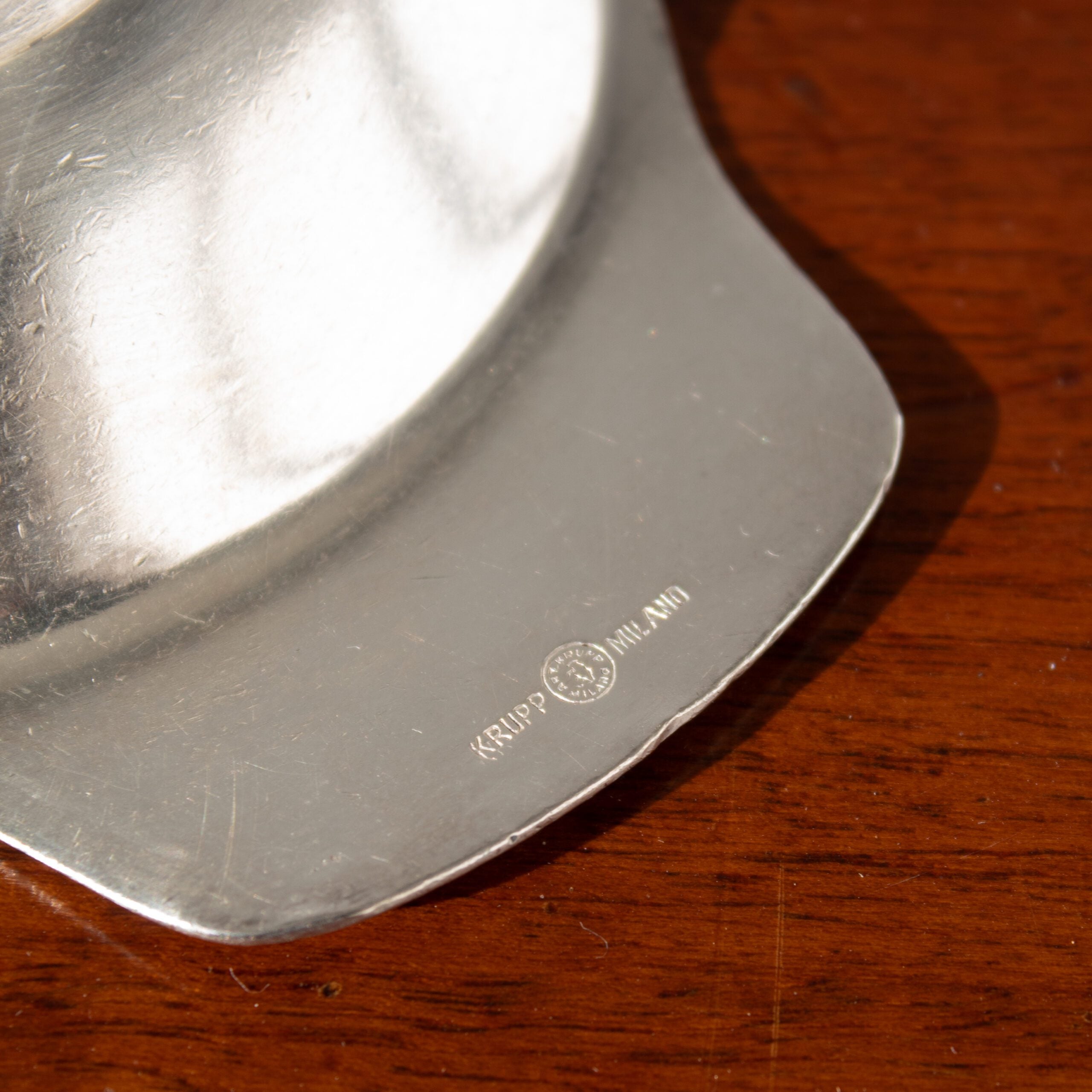 Arthur Krupp Dessert Plates in Metal — close-up of polished metal surface