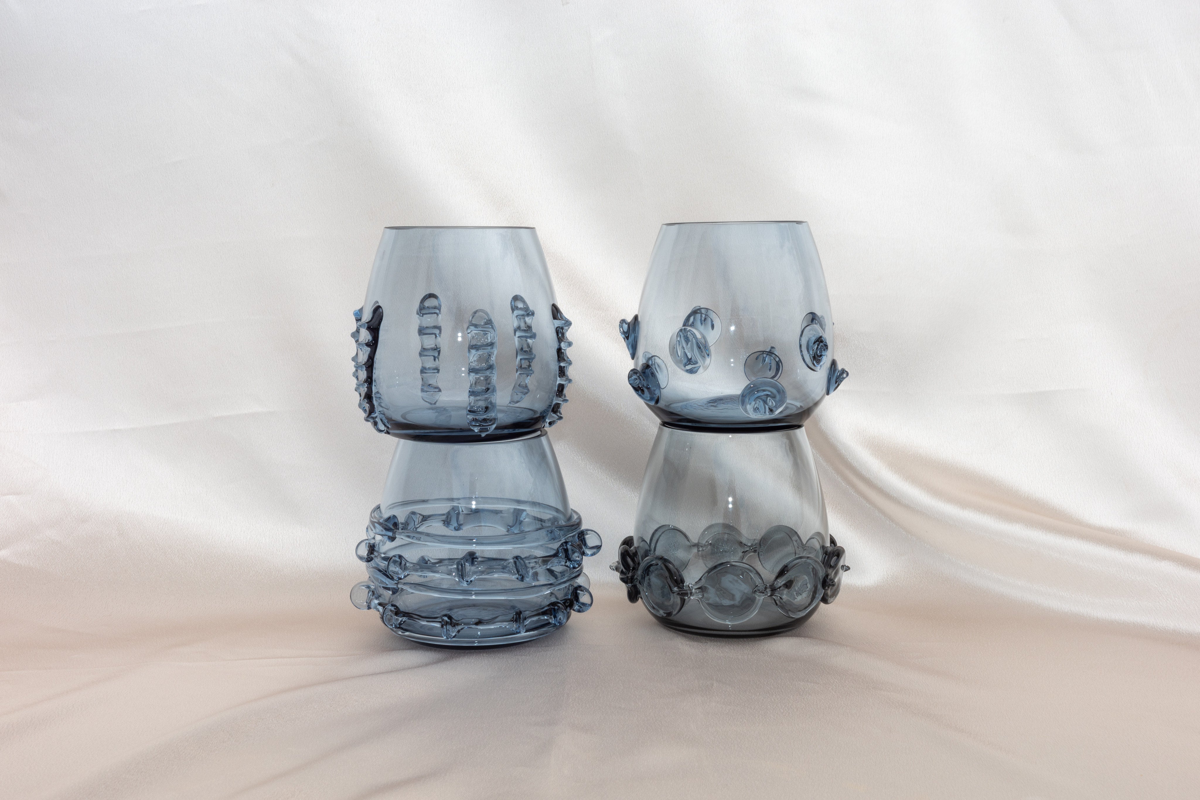 Contemporary Tumblr - Set of four handblown glass vessels — back view showing textured blue glass