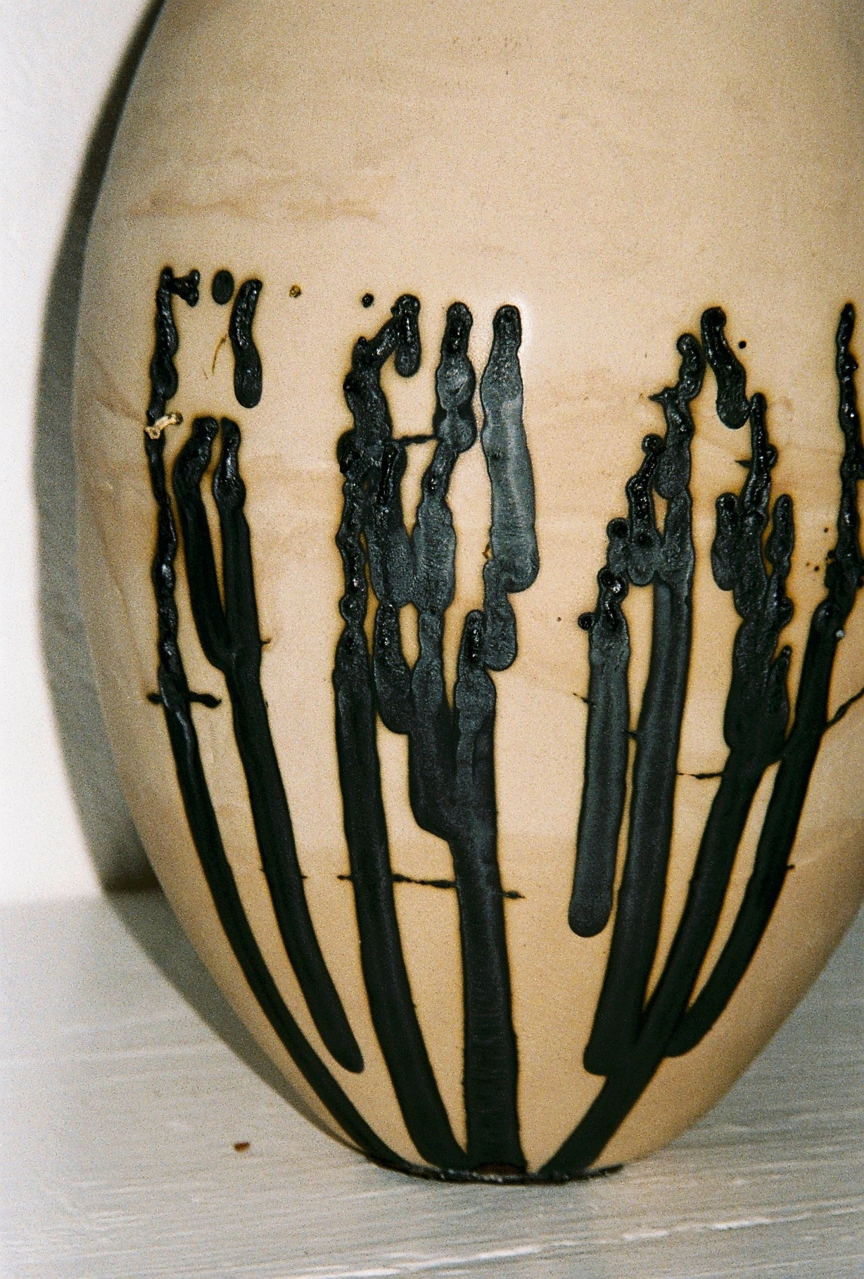 FEAR Vessel — close-up of ceramic surface with black glaze details