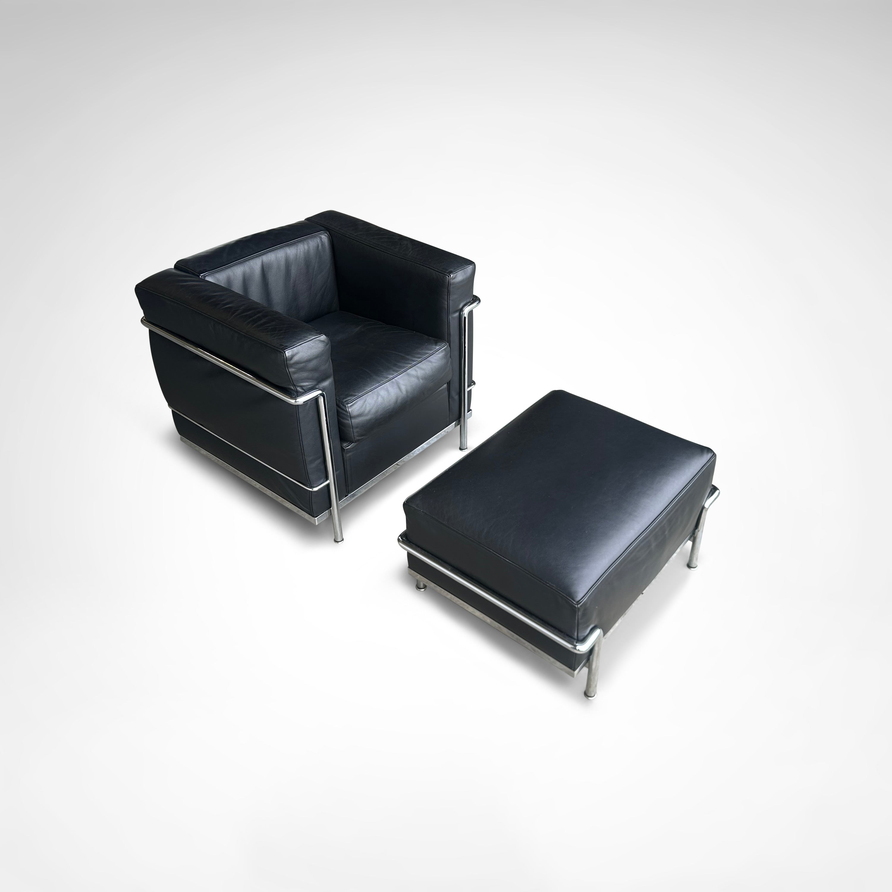LC2 Armchair and Ottoman by Le Corbusier et al. for Cassina 1990s — angled view showing black leather upholstery and chrome f