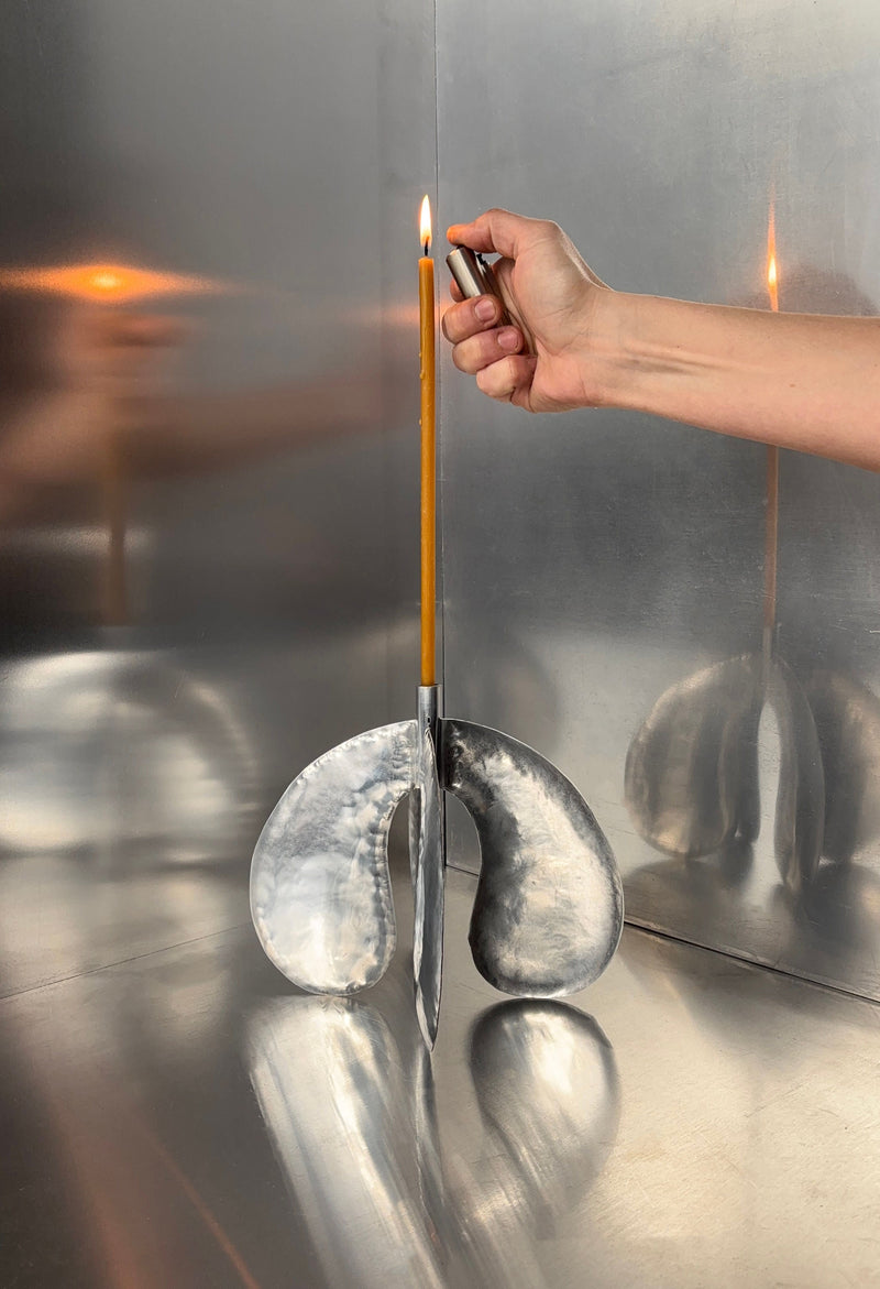 Phaedra Candle Holder Large — hand lighting candle in polished metal holder