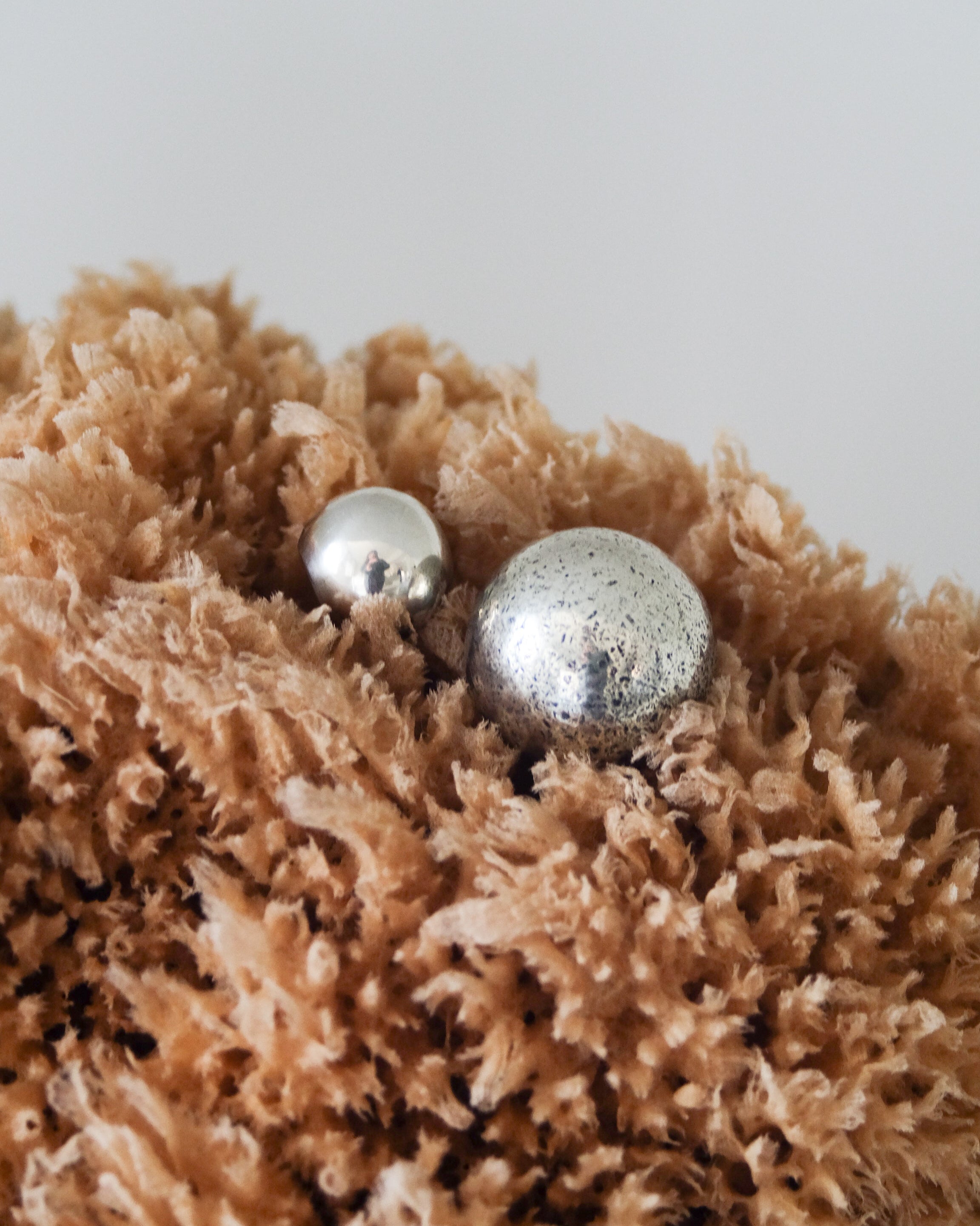 CERCLE Cabinet Knob Large — top view of silver knobs on textured fabric