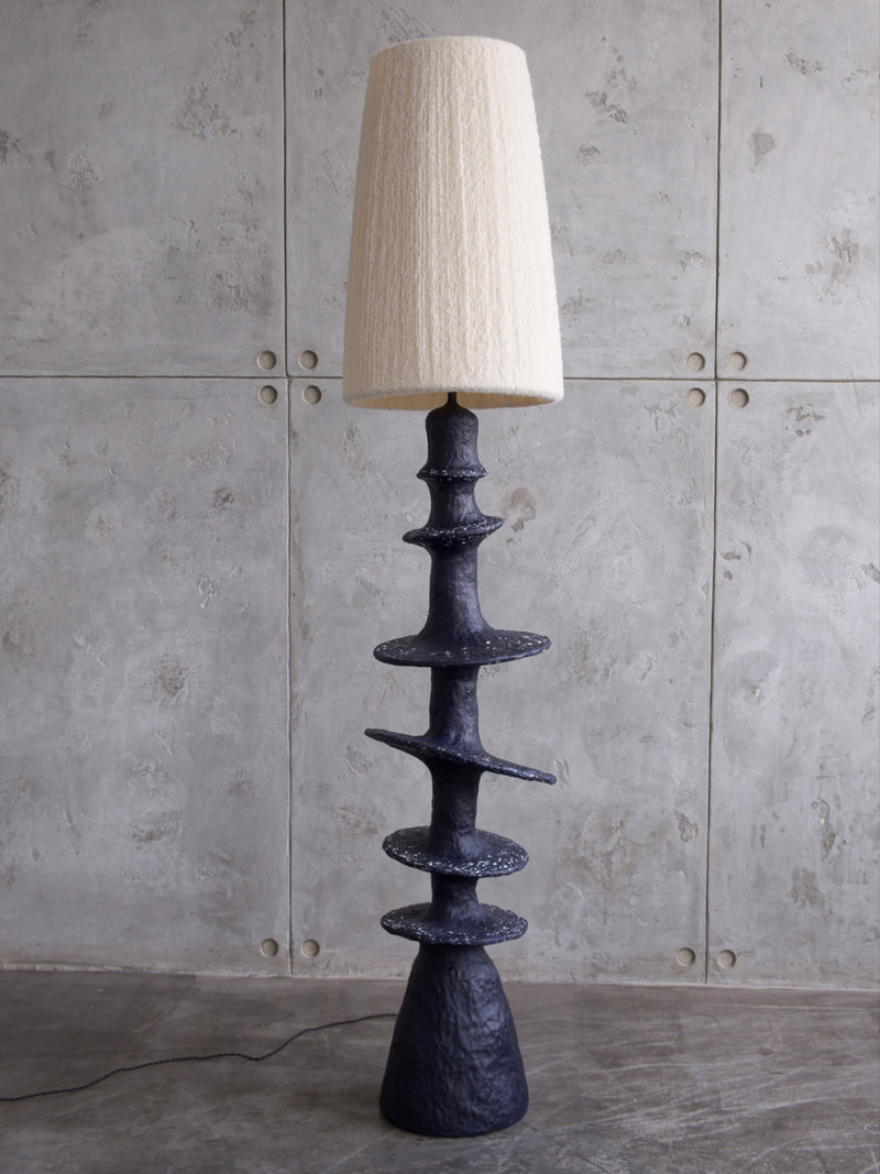 Orbita Floor Lamp — close-up of textured black base and cream shade