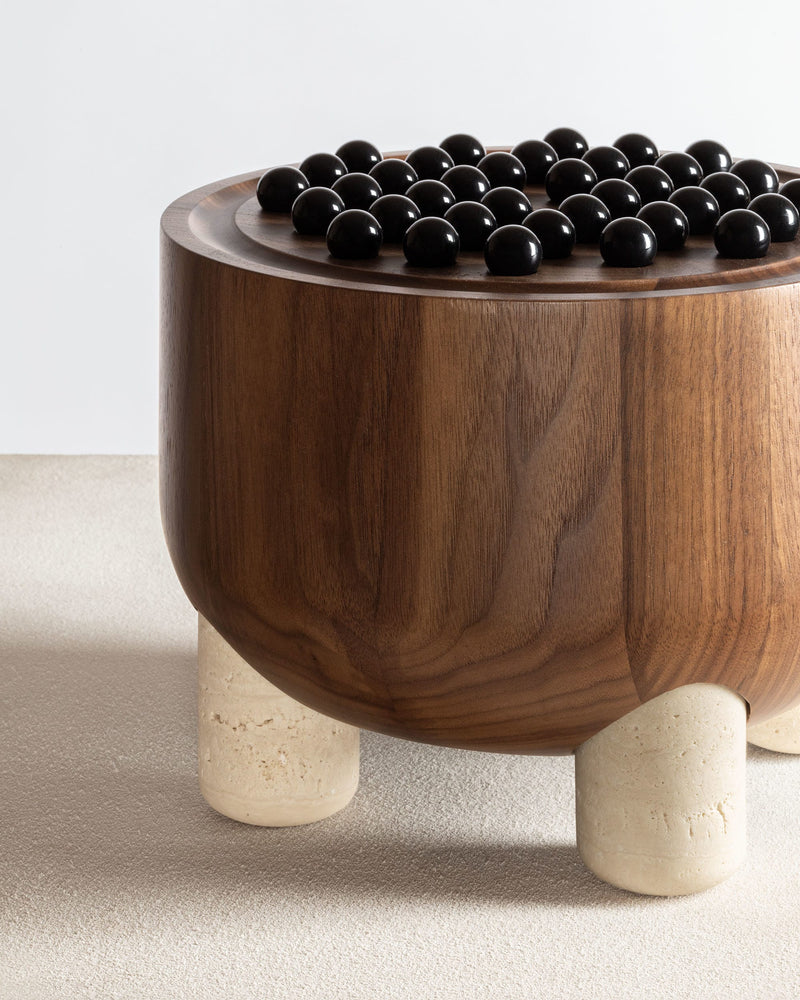 Mocambo walnut peg solitaire game with black marbles on stone legs
