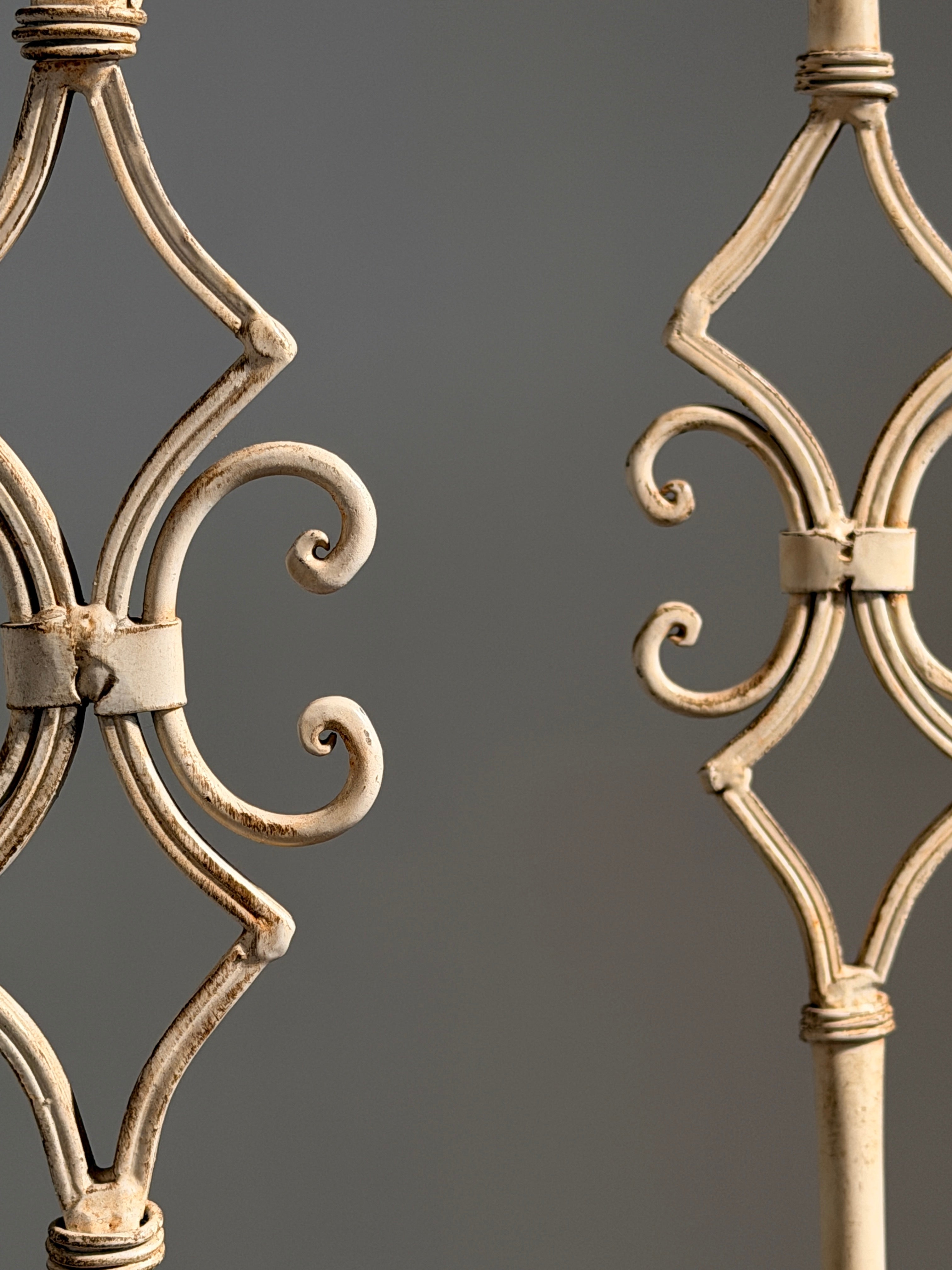 Pair of large cream-painted wrought-iron pricket candlesticks, Italy — lifestyle setting