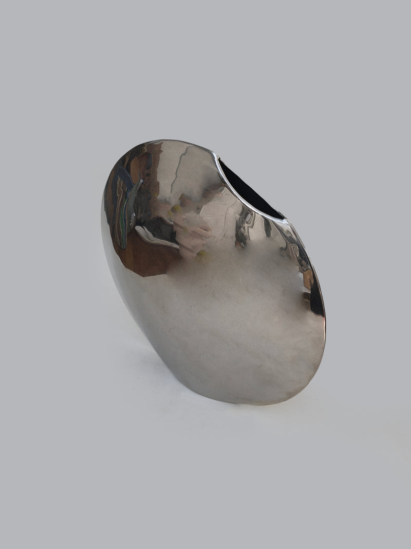 Pair of Round Vases — close-up of polished metallic surface