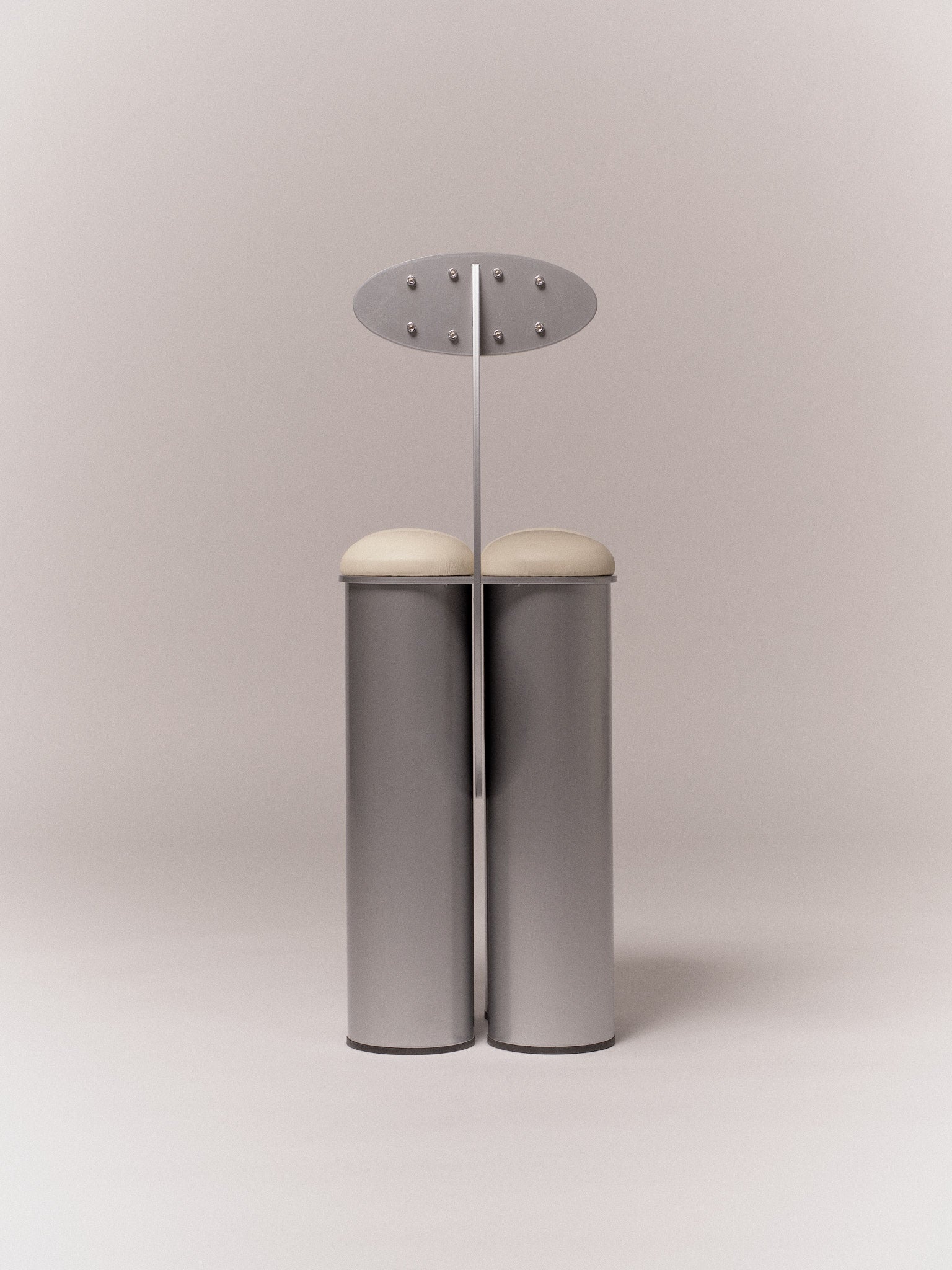 Giulio Stool — front view of polished metal frame with cream seat