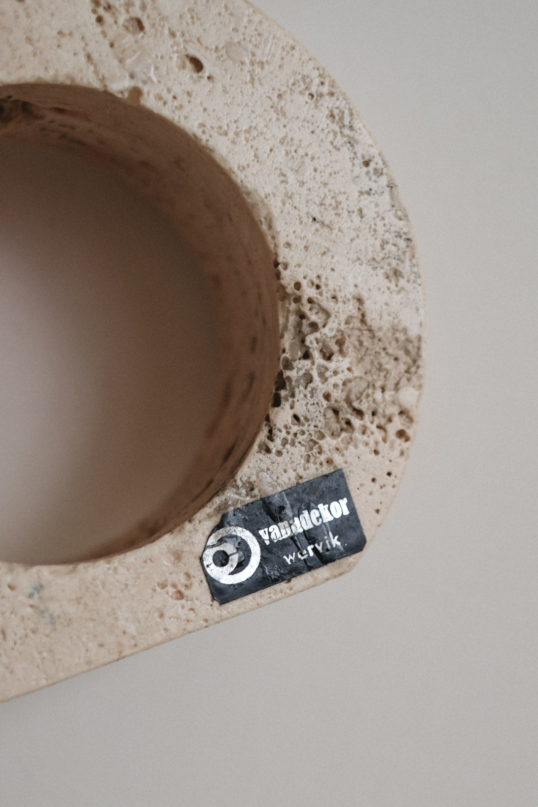 Travertine Candle Holder — top view showing textured surface and label