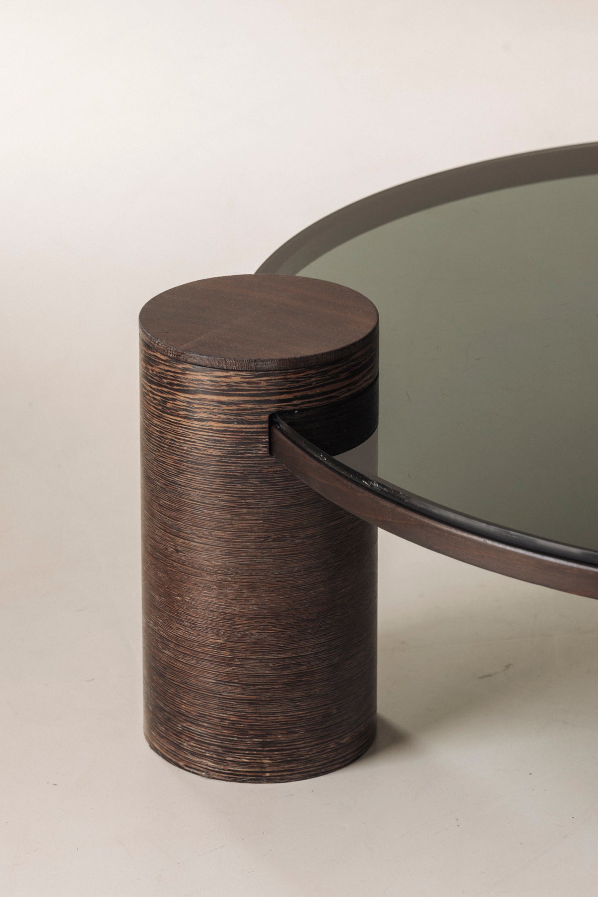 Sculptural Brutalist Wengé and Smoked Glass Round Coffee Table, 1970s — lifestyle setting