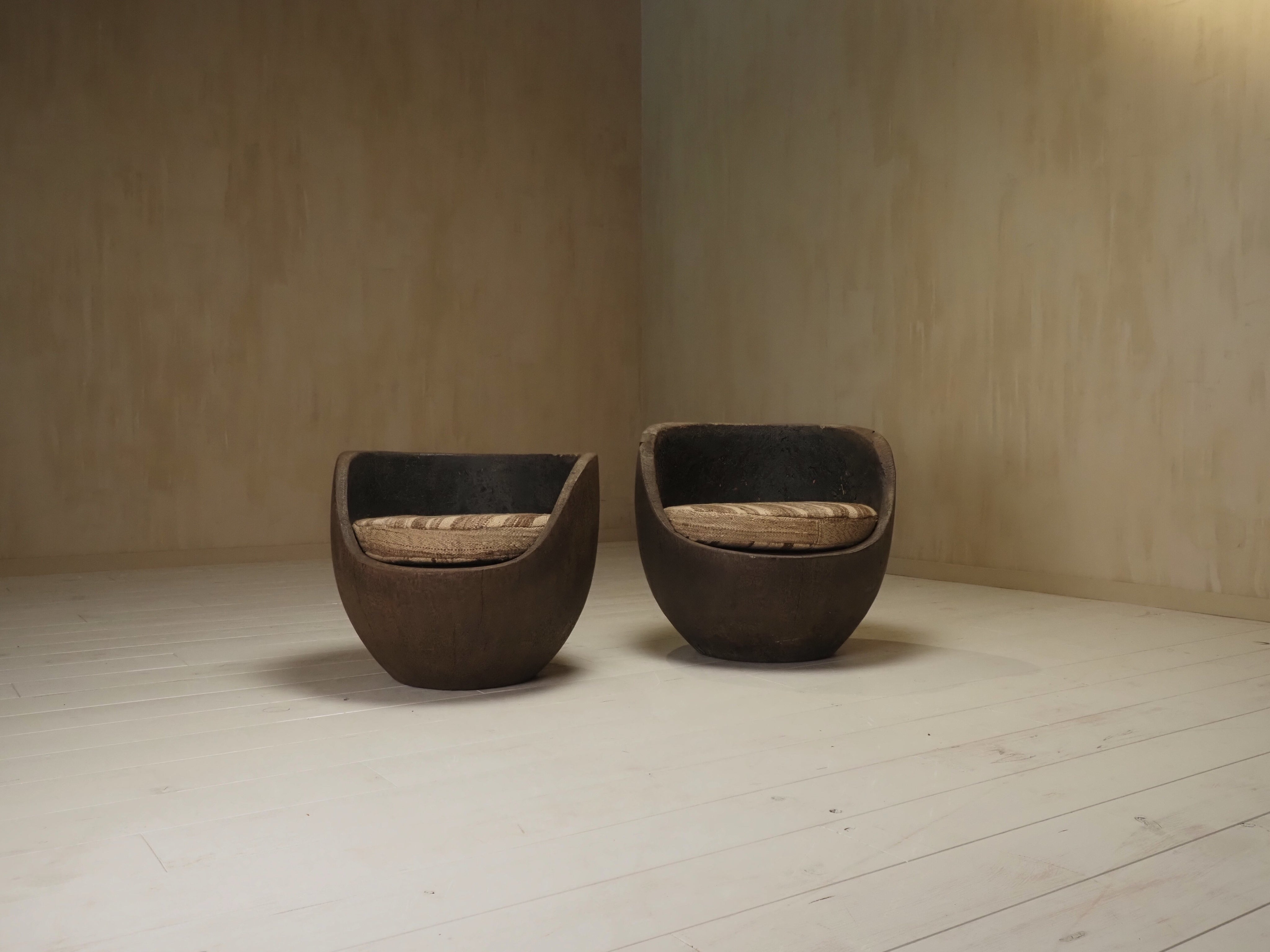 Sculptural mid-century hand-carved pair lounge chairs — side angle