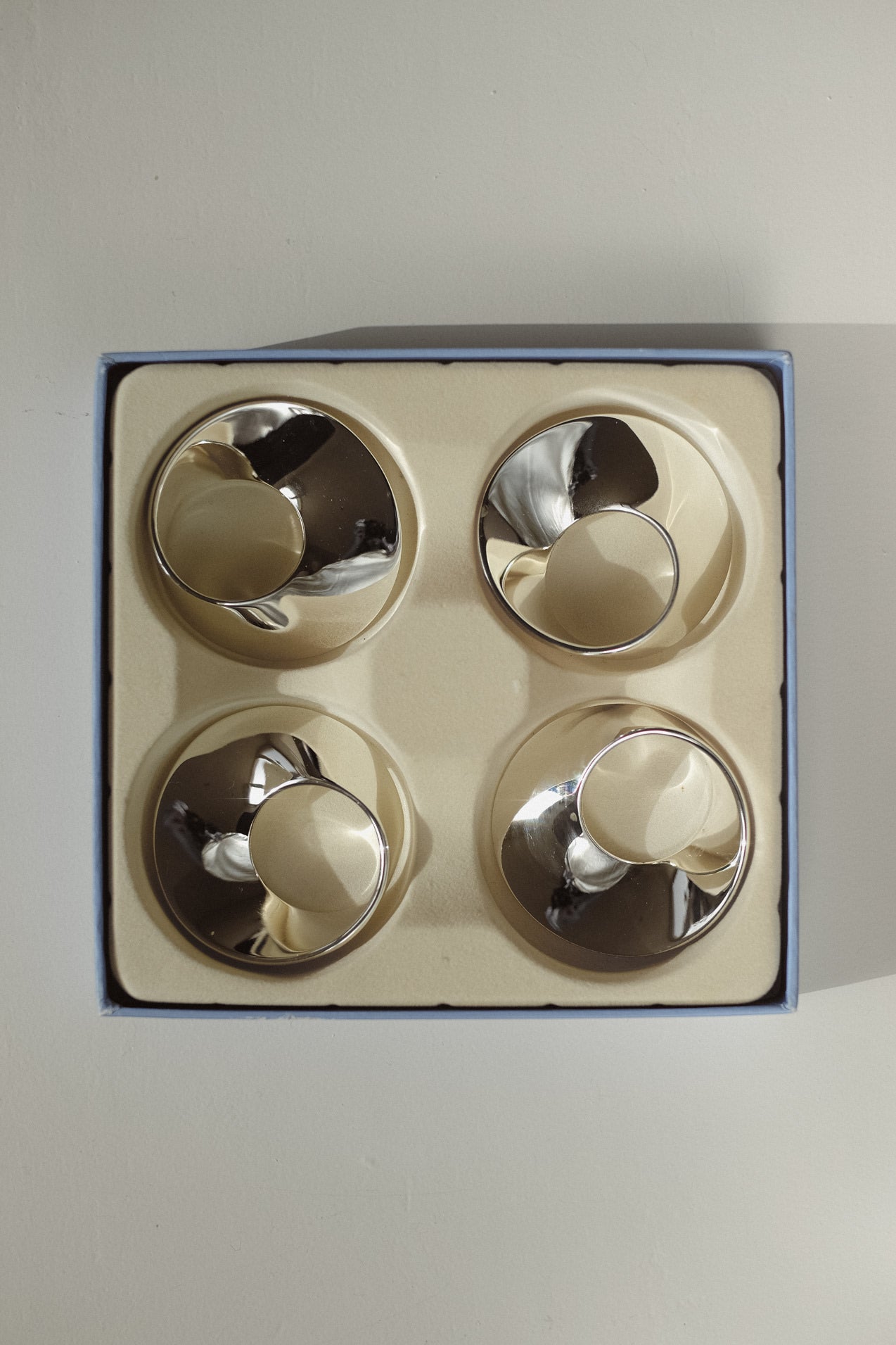 Set of 4 Silver-Plated Napkin Rings — top view in blue gift box