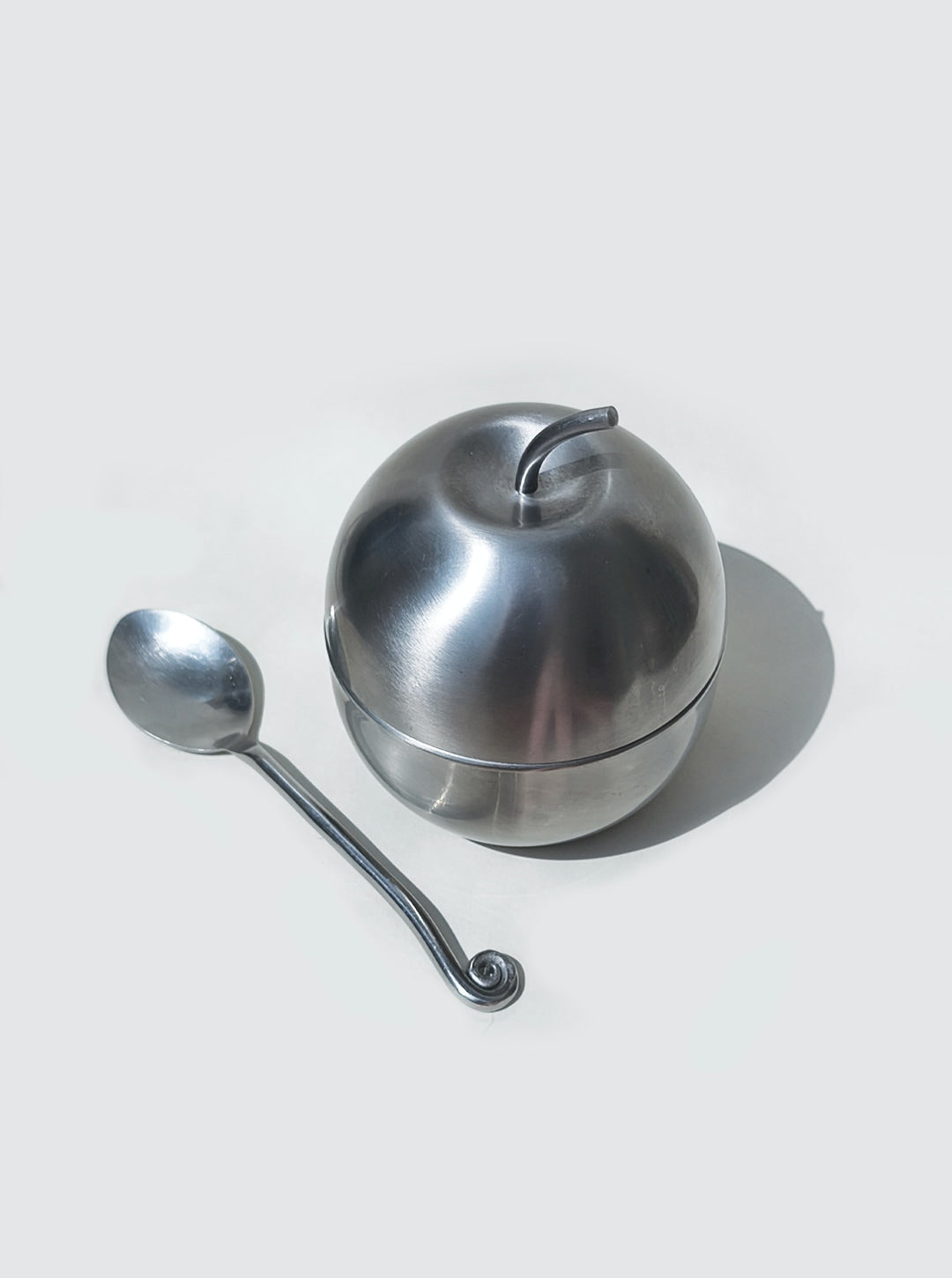 Sugar Apple Bowl — side angle showing brushed metal finish with spoon