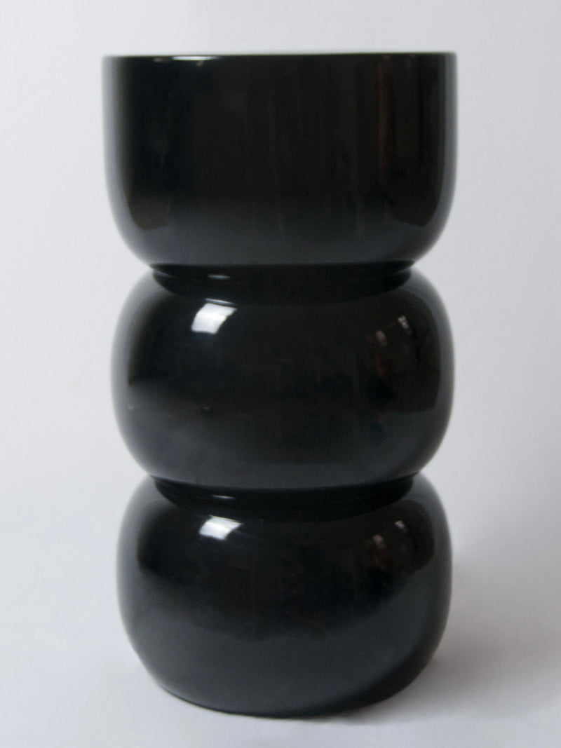 Chess' Stool convex in lacquer wood — front view of glossy black finish