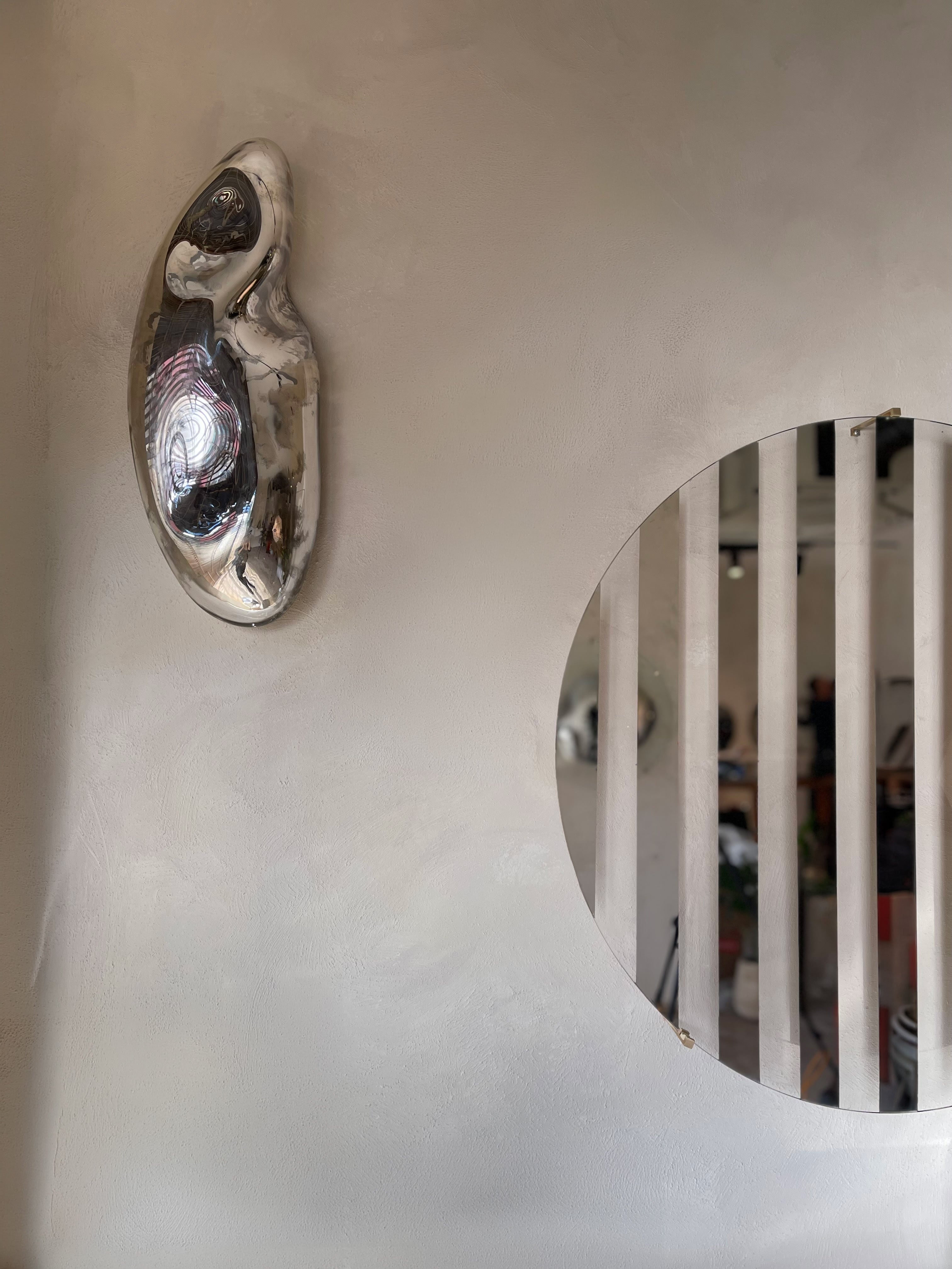 Line III Mirror — side view against textured wall