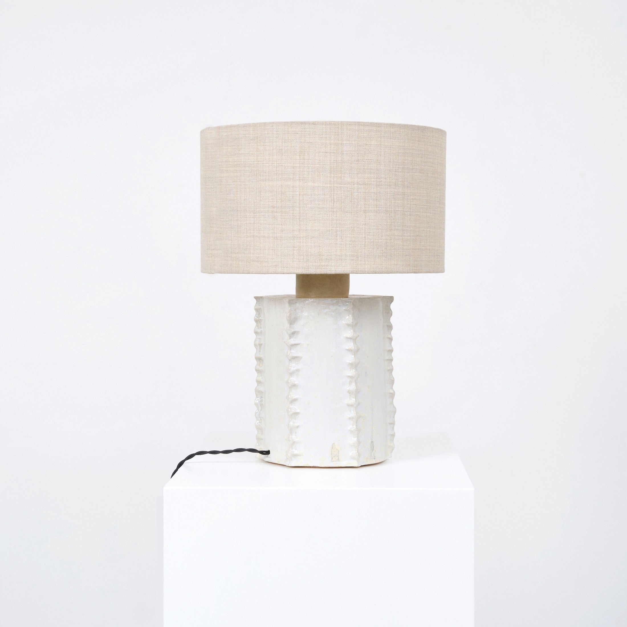 Totem Table Light — side view of textured ceramic base with linen shade