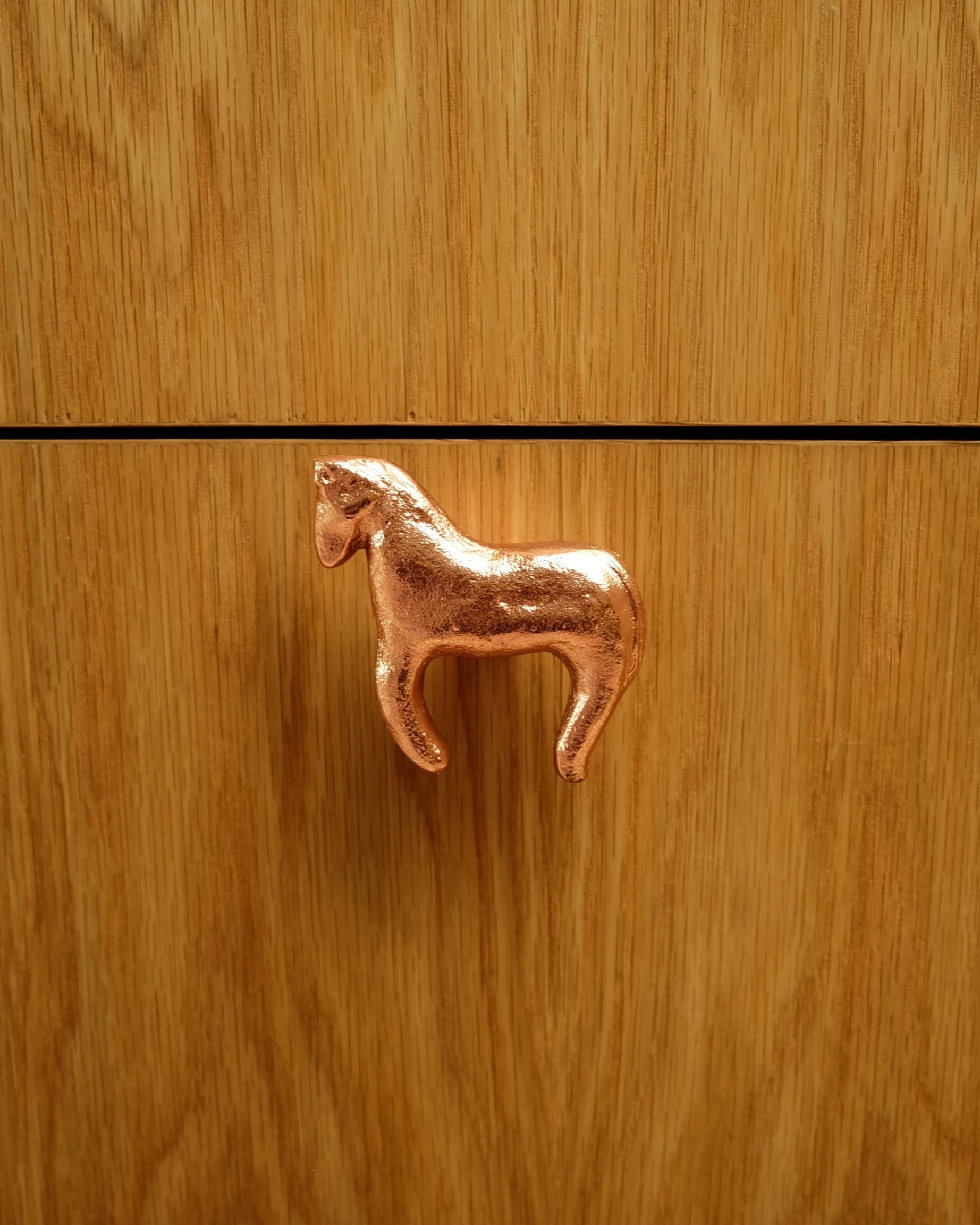 FOAL Cabinet Knob/Wall Hook — close-up of copper horse design on wood