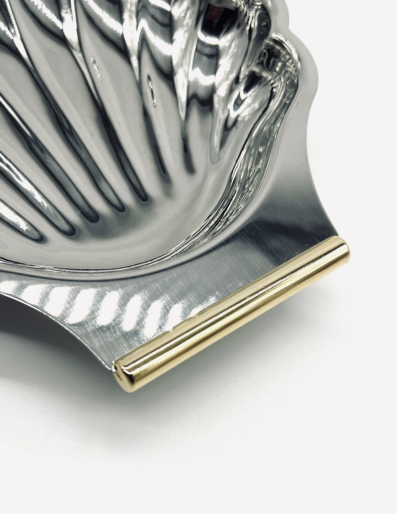 Close-up detail of gold-trimmed edge on vintage shell dish