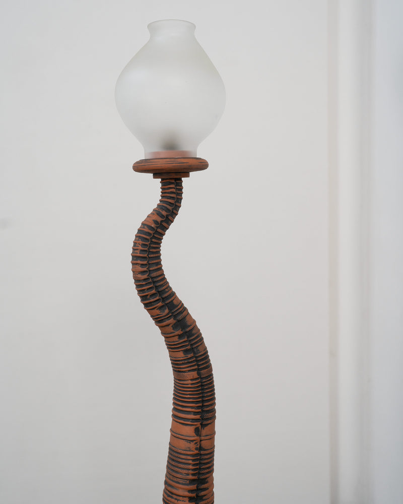 Curved terracotta stem detail of vintage sculptural floor lamp