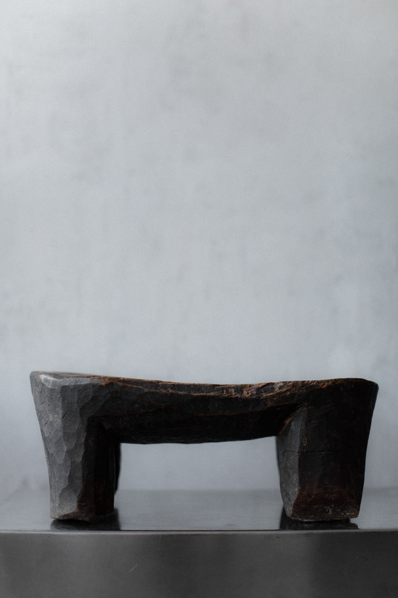 Senufo Stool — side view of handcrafted dark wood design