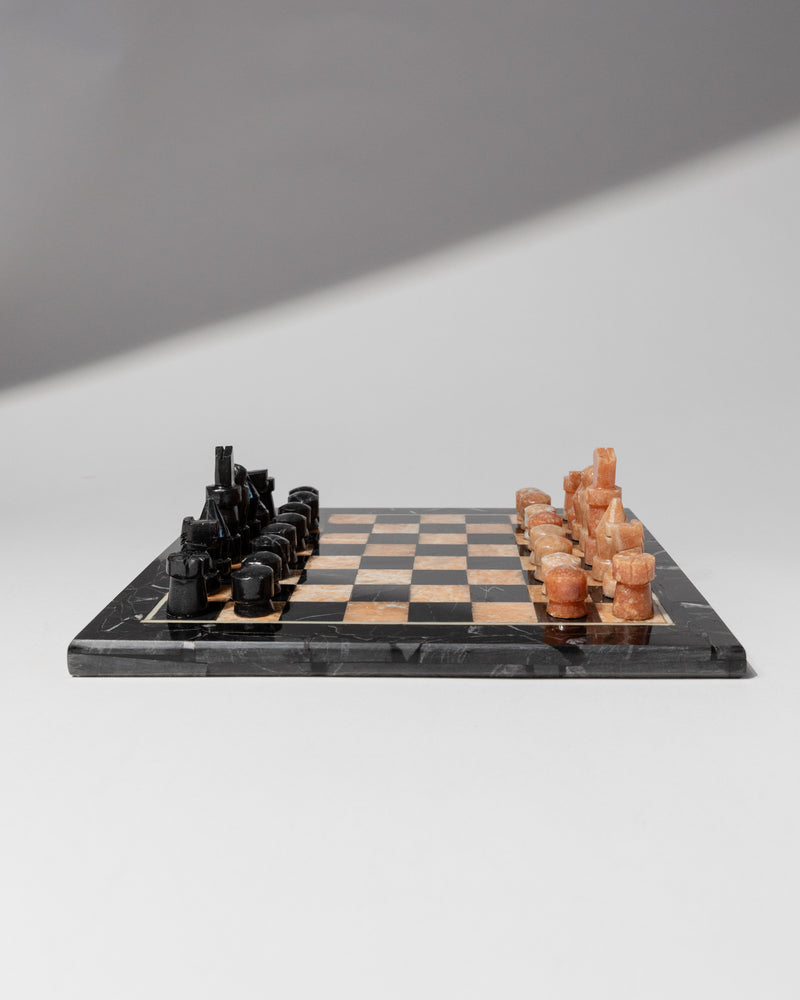 Italian marble chess set with black and orange pieces on checkered board