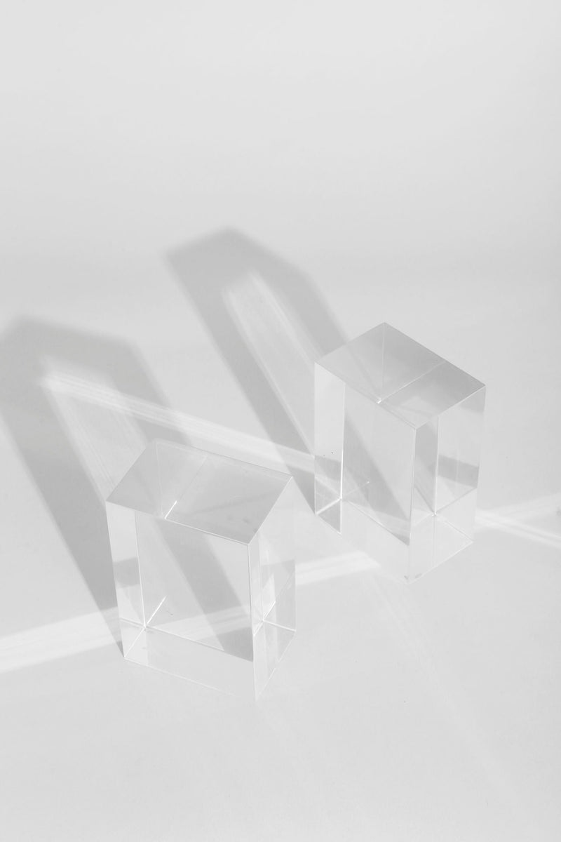 Clear acrylic bookend blocks showing transparency and geometric edges
