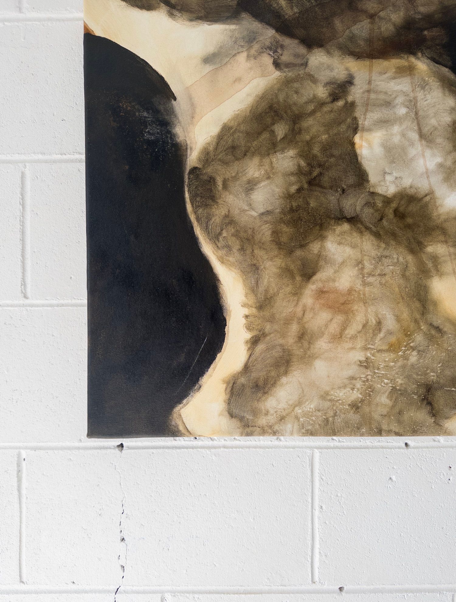 A close-up of Natasha France's 'Nightfall Over Olympia' Mixed Media hangs on a white cinder block wall, with a visible vertical crack running beneath it.